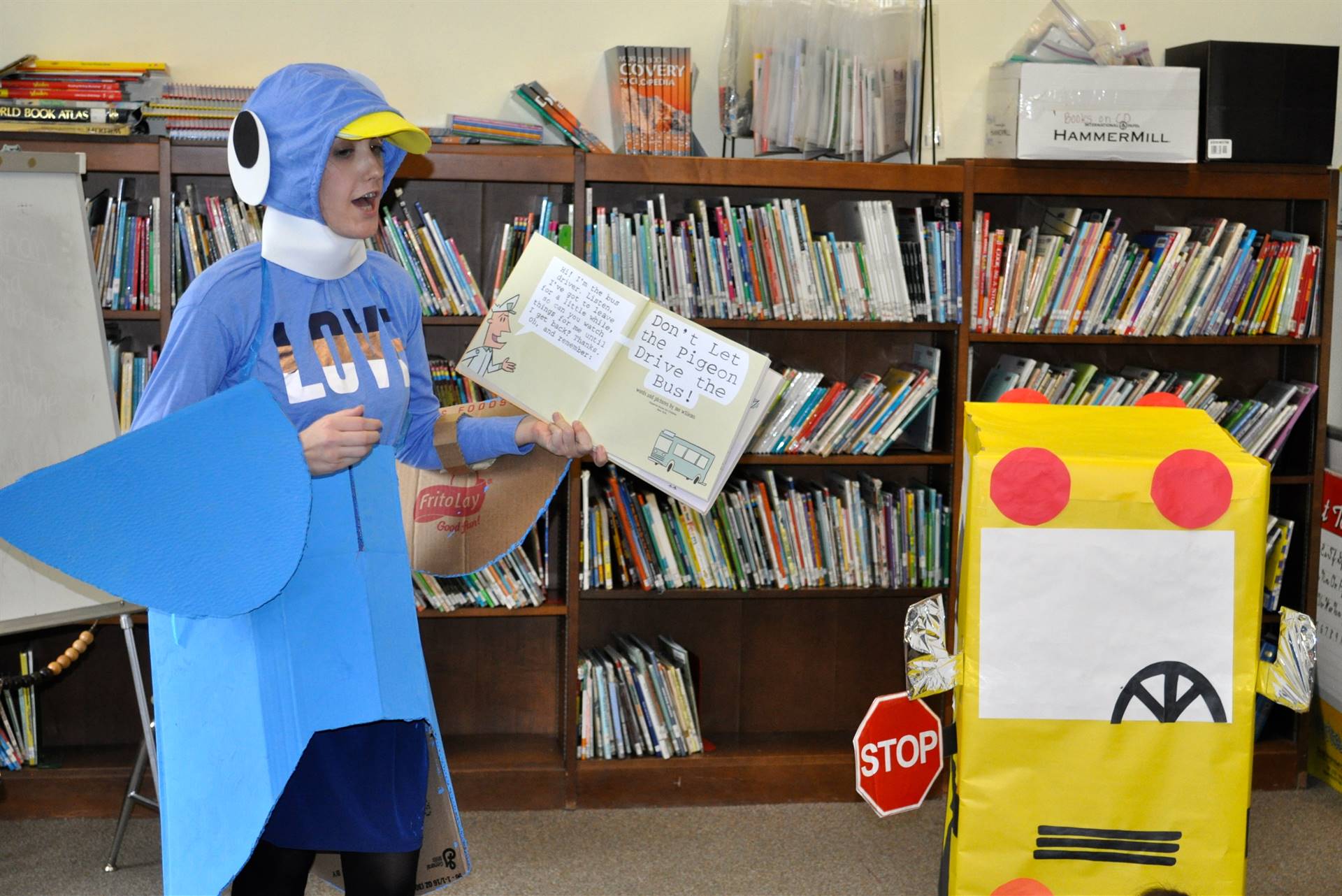 Teacher dressed up like a pigeon reading to students.