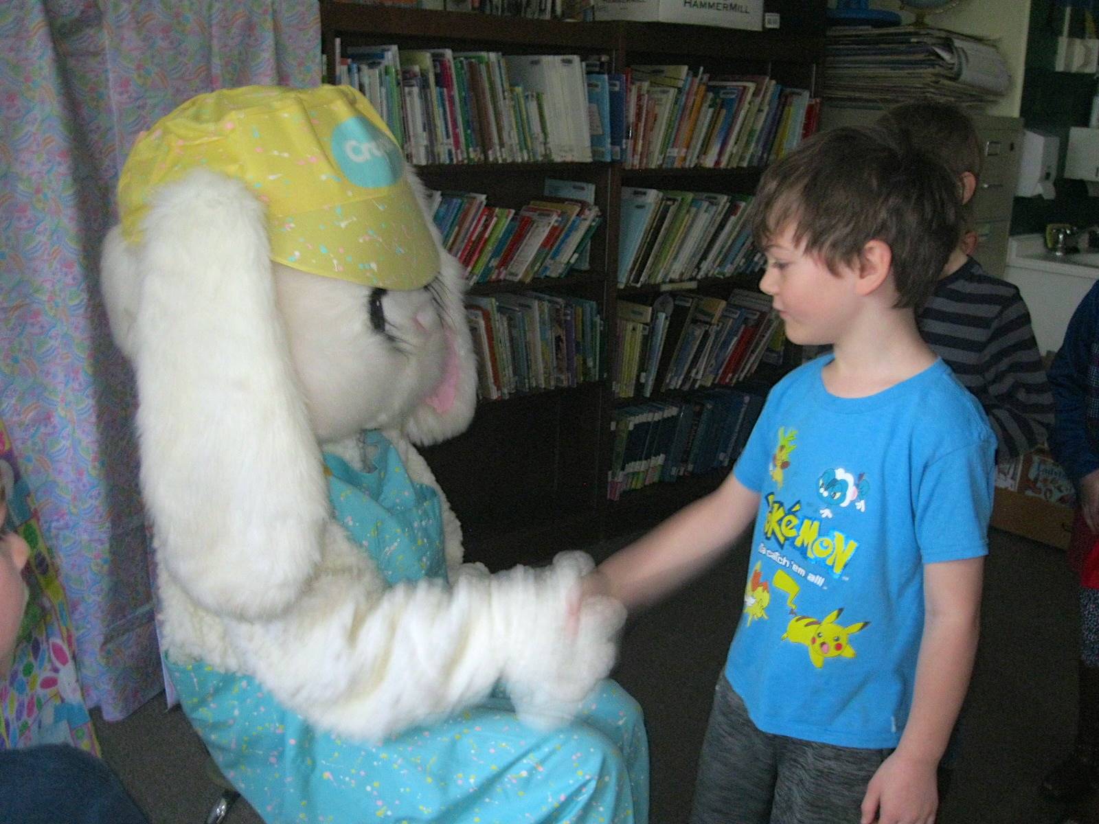 Student shakes hands with Easter Bunny
