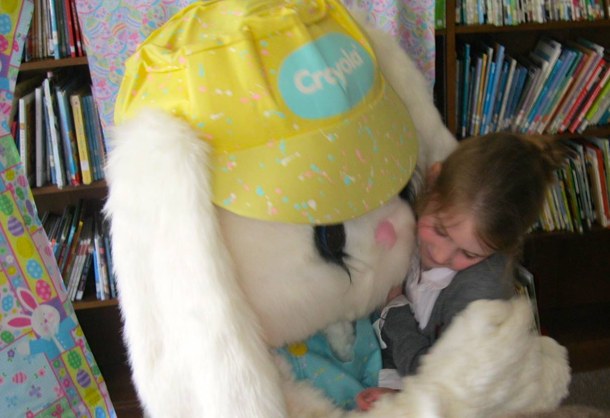 Student hugs Easter Bunny.