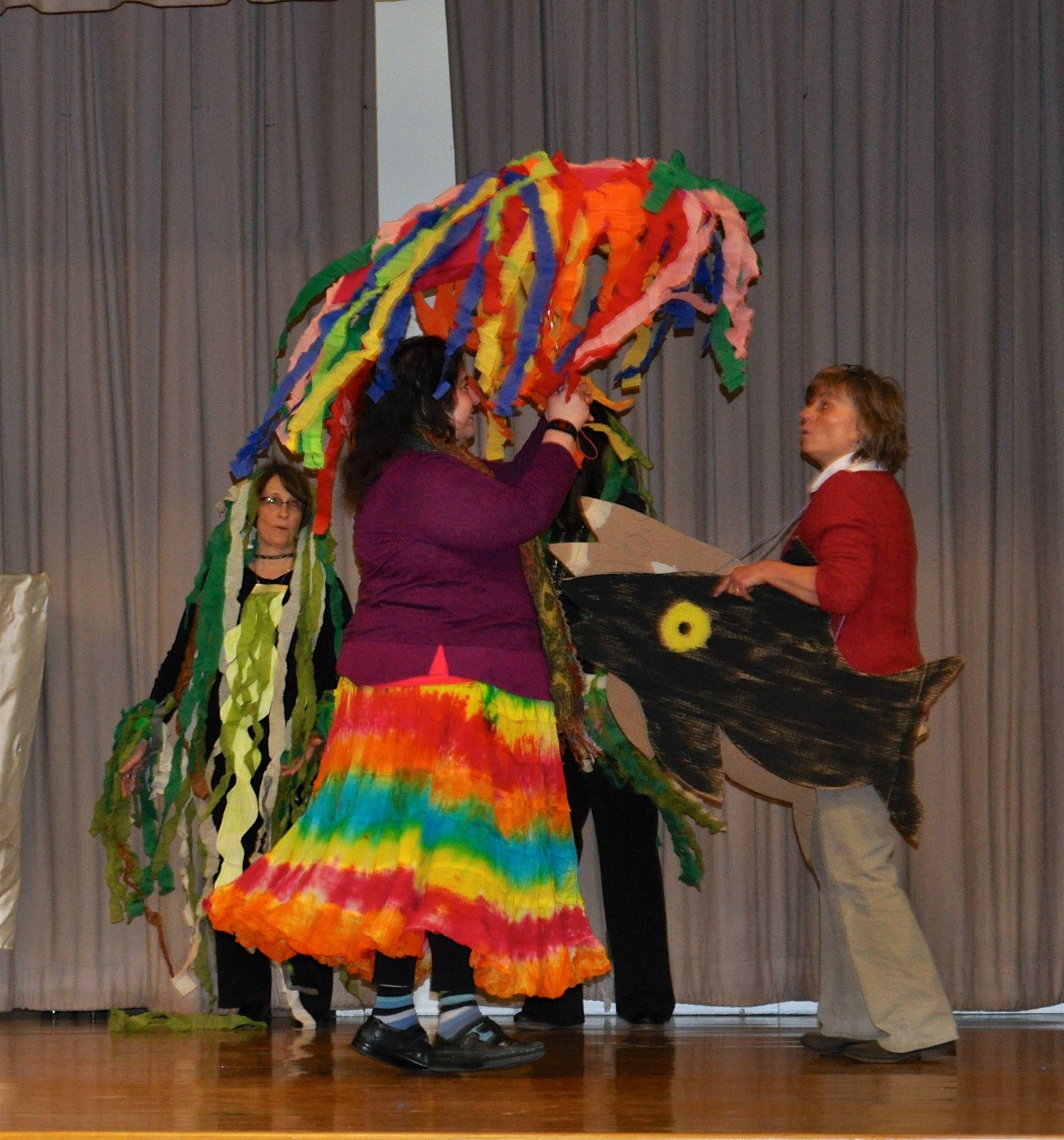 Teachers on stage acting out "Swimmy".