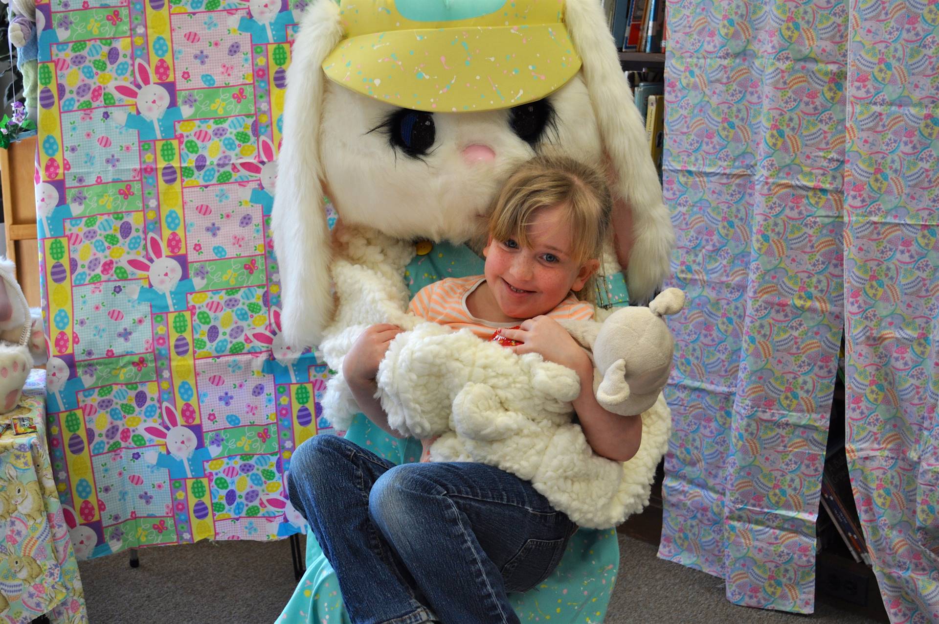 A child snuggles up with the Easter Bunny.