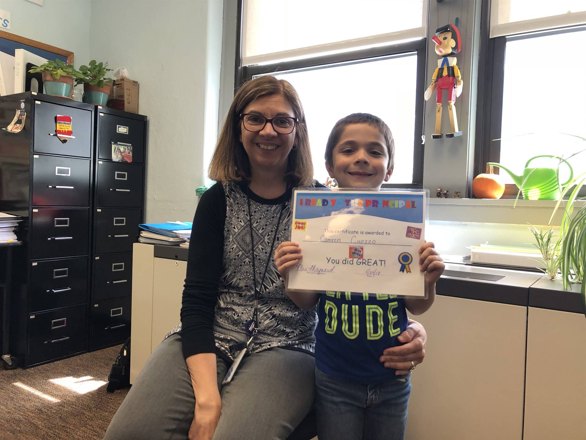 First grader proudly reads to the principal!