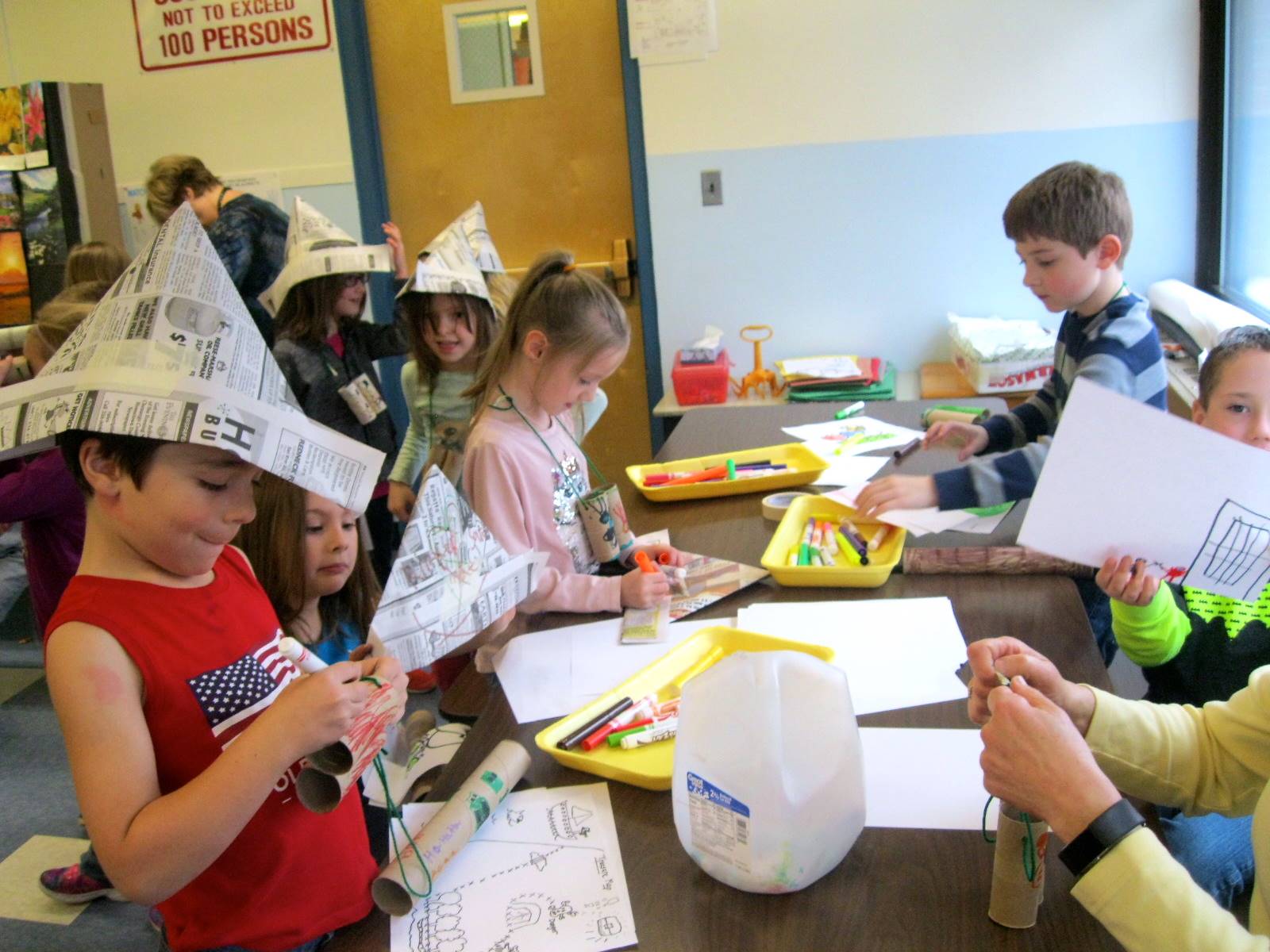 First graders busy creating binoculars at first grade Art Fair.