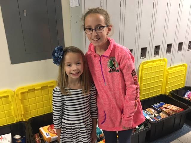 Two students packing totes for the Food Drive