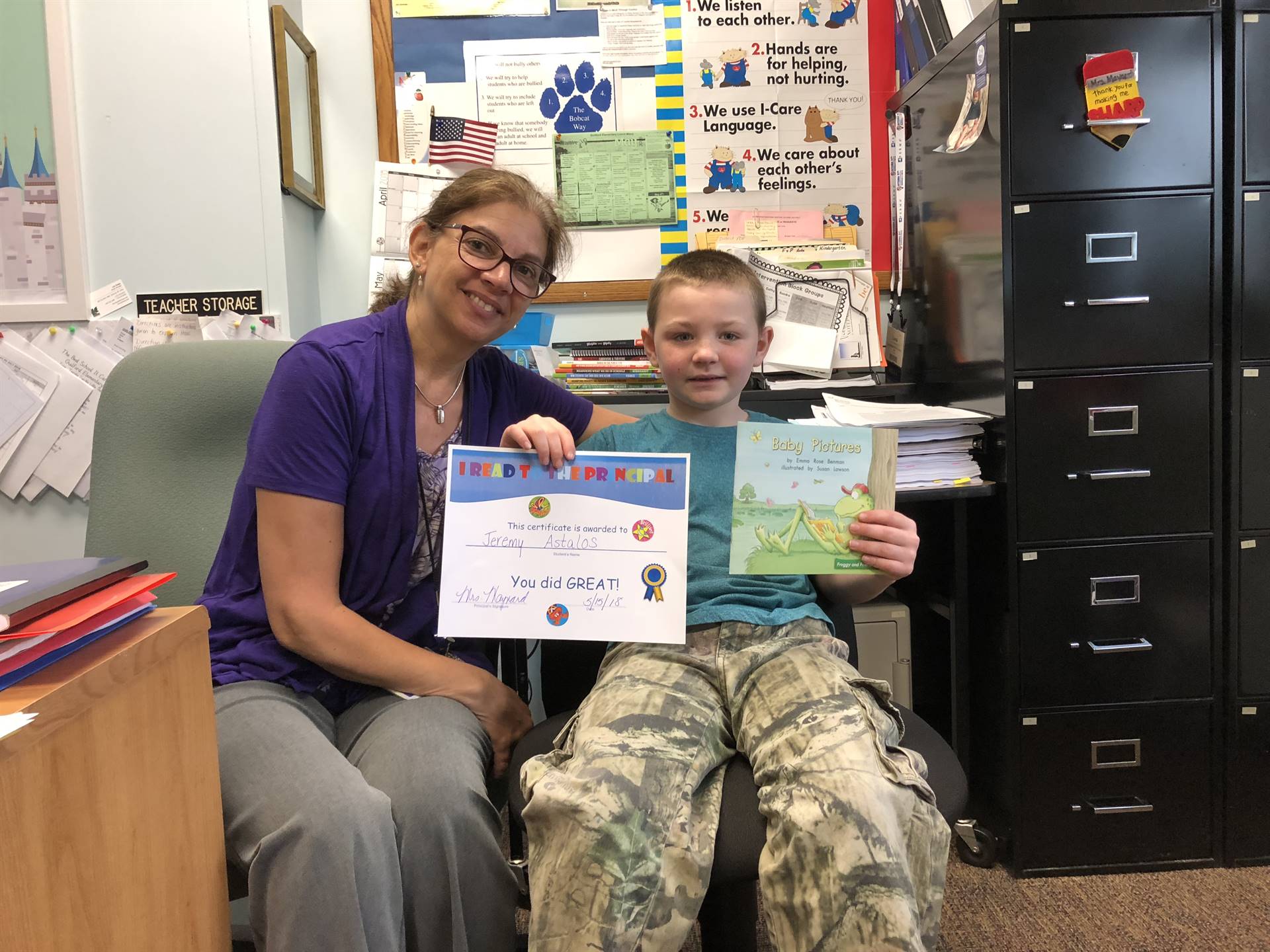 Principal and first grader read together.