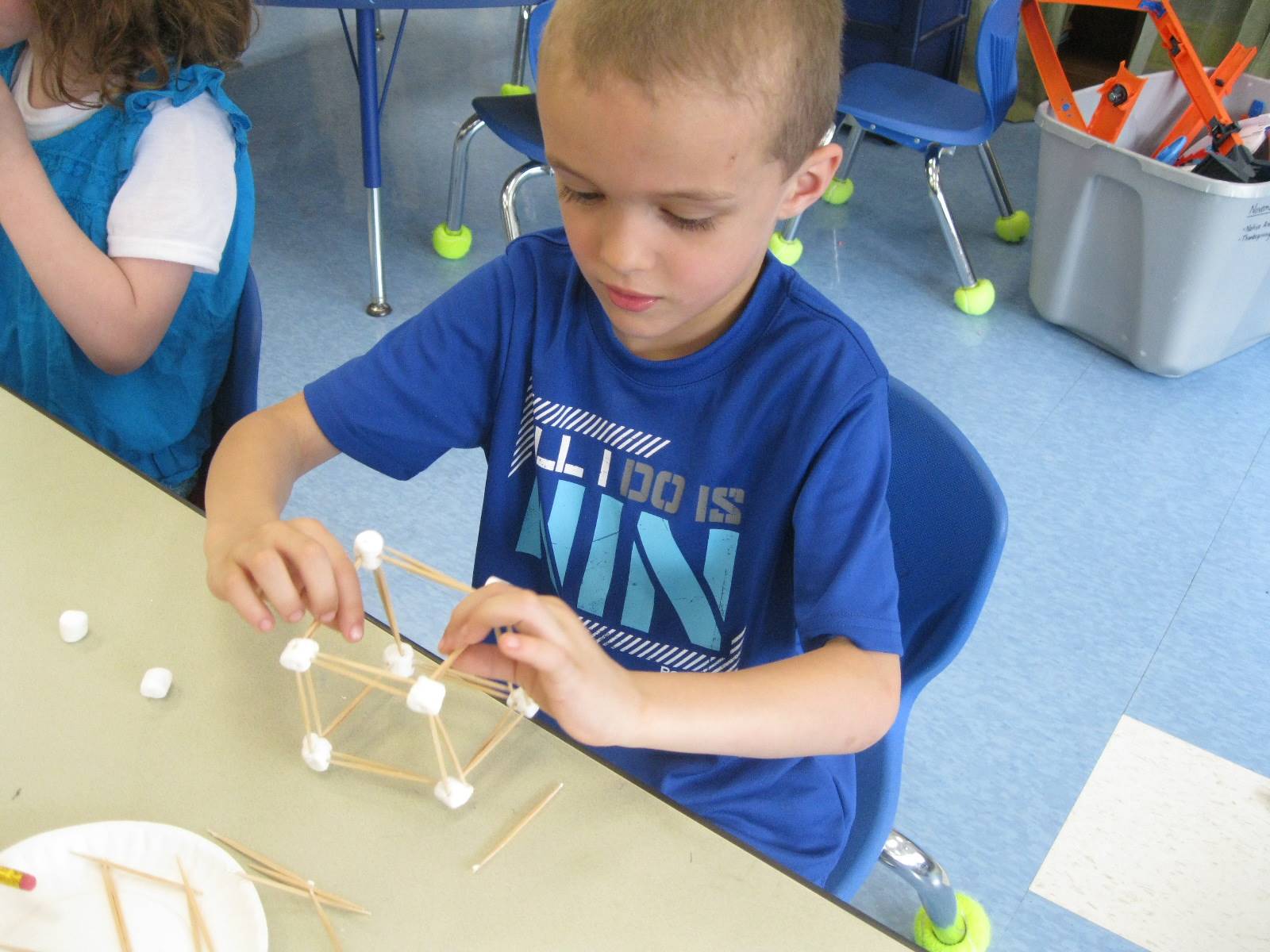 student doing math with marshmallows and toothpicks.