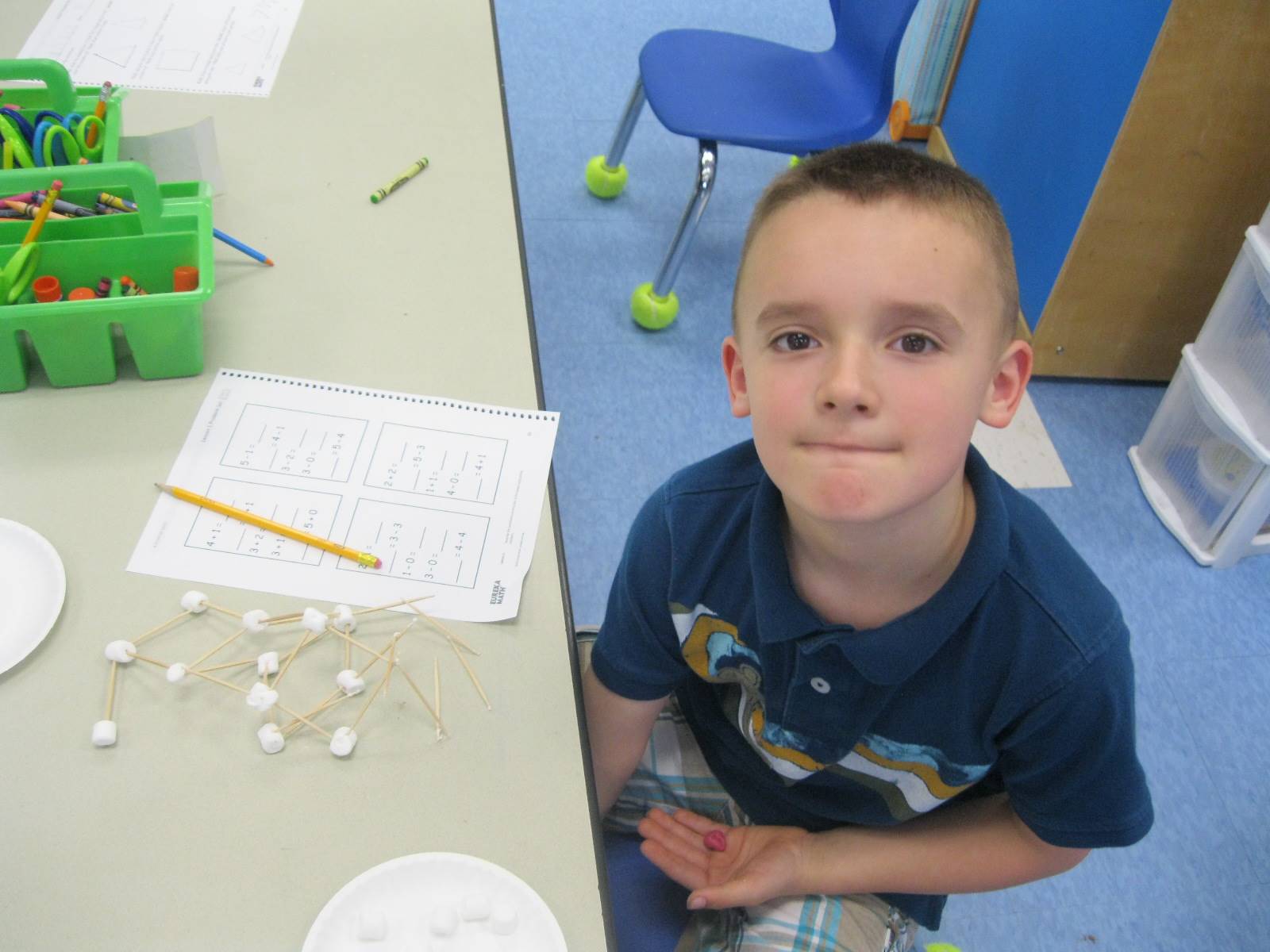 student creating math from marshmallows and toothpicks.