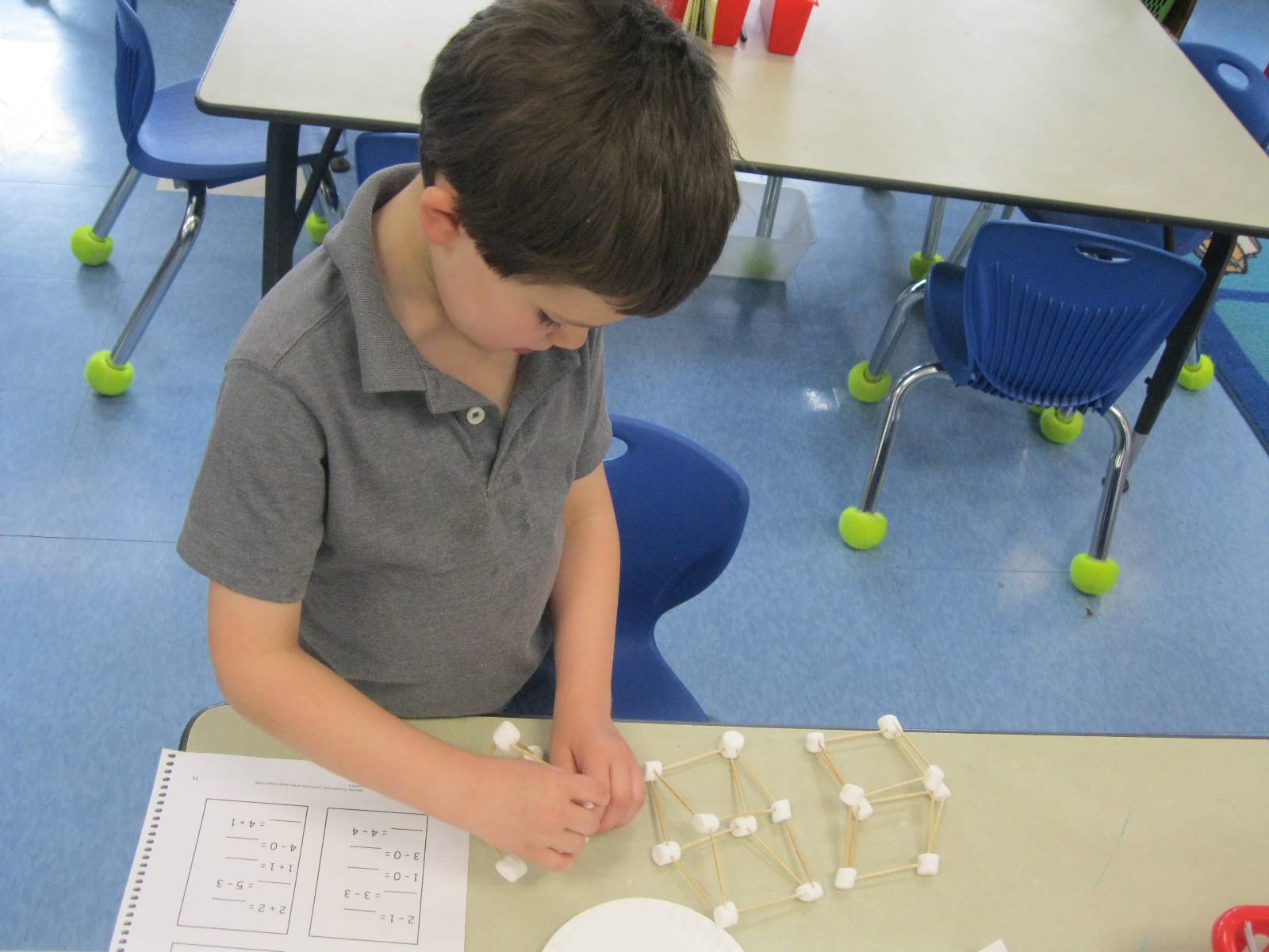 student creating math from marshmallows and toothpicks.
