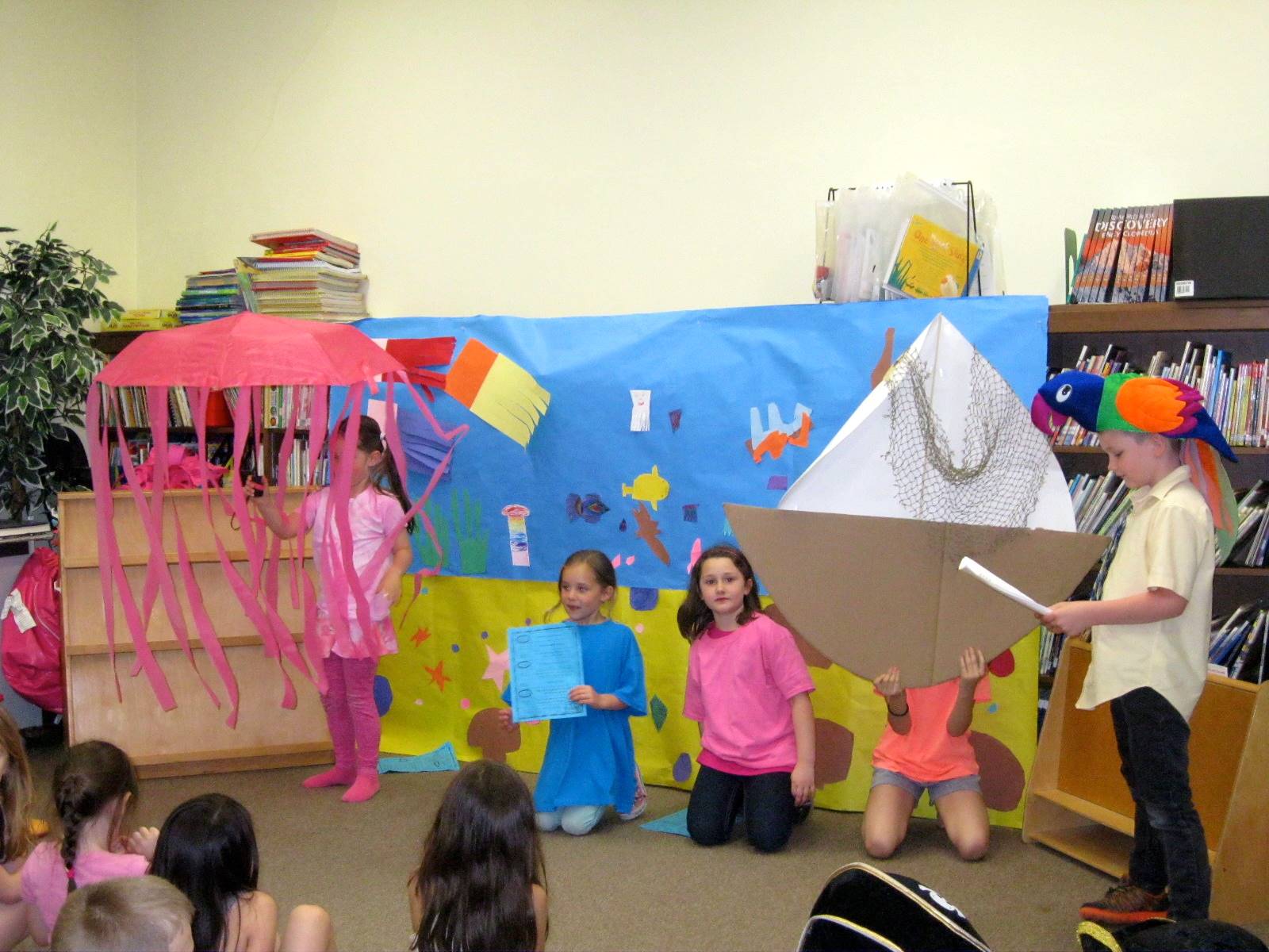 first grade students deliver a play. 