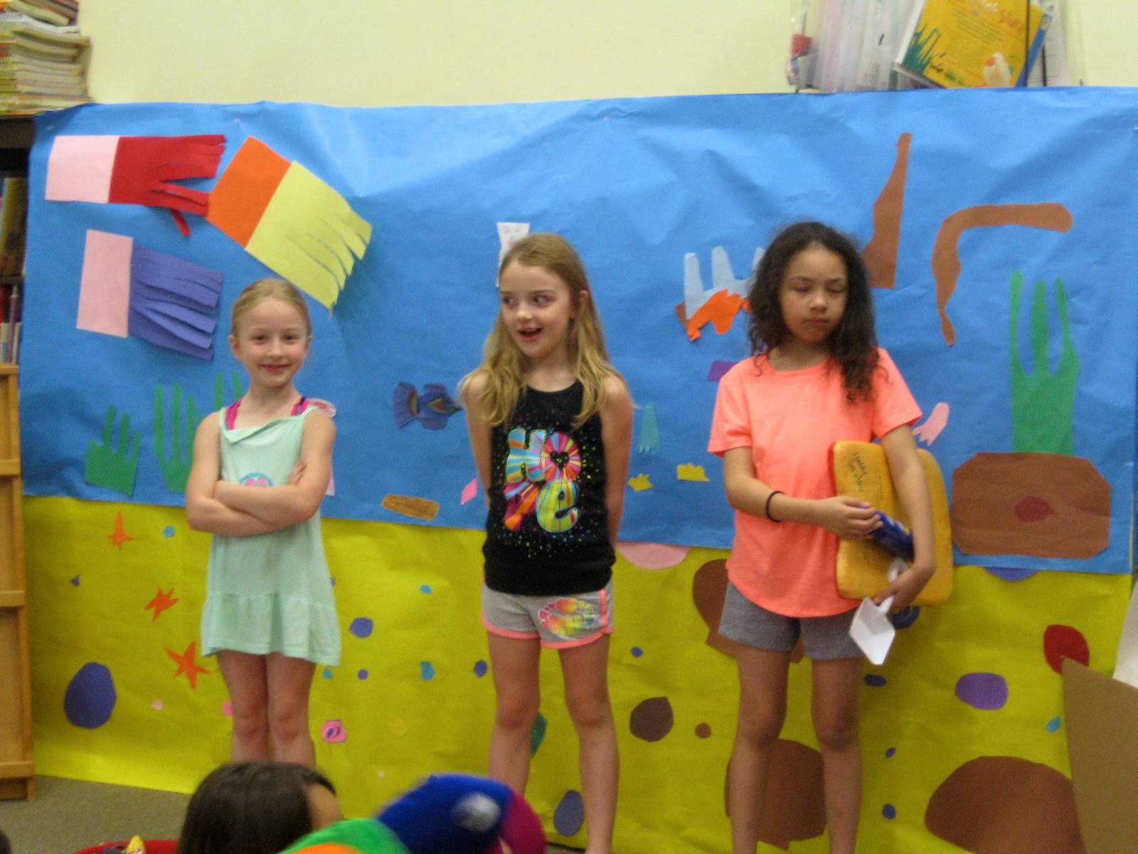 first grade students deliver a play.