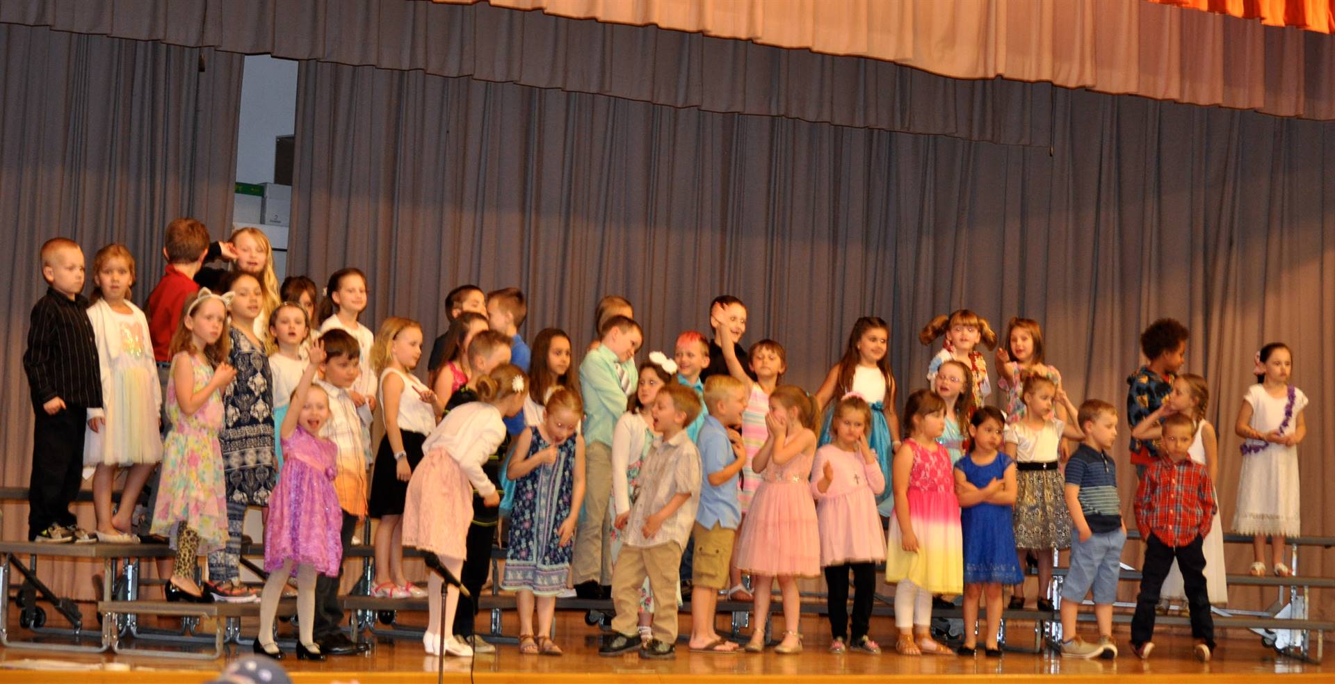 first grade students singing at primary school concert 