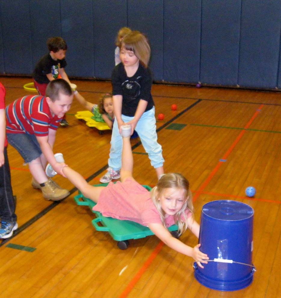 Kindergartners work together playing "Hungry Hippos"