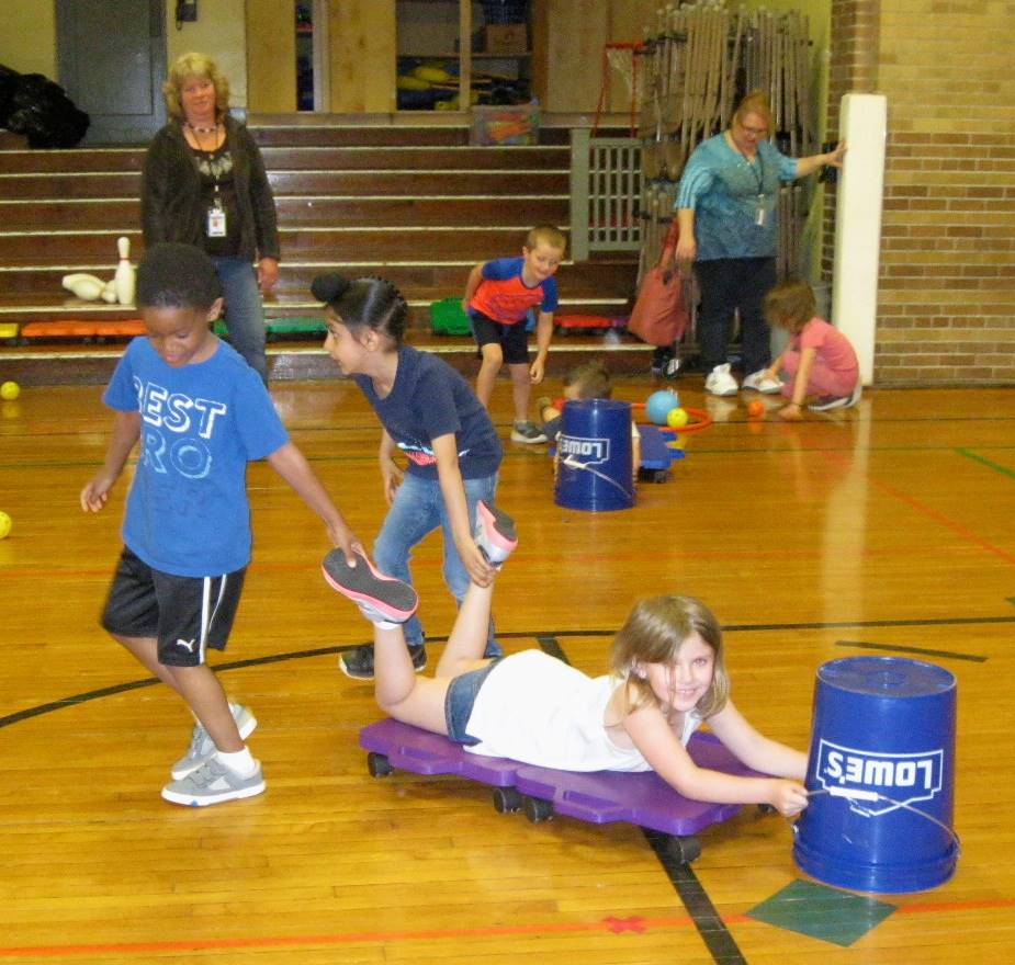 Kindergartners work together playing "Hungry Hippos"