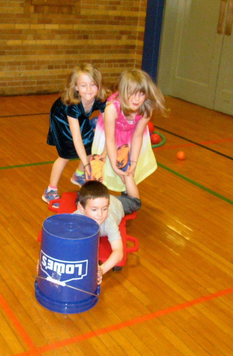 Kindergartners work together playing "Hungry Hippos"