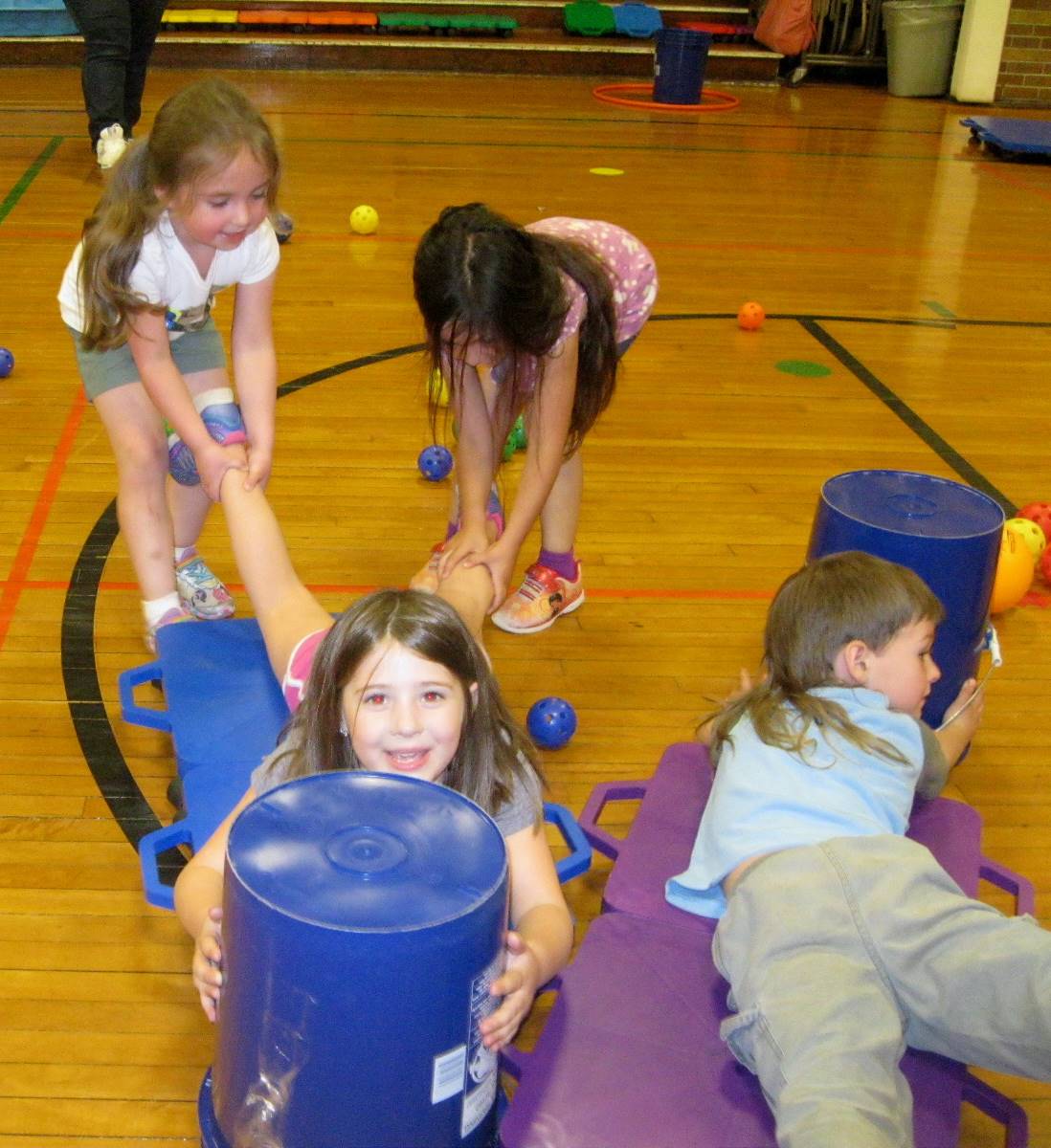 Kindergartners work together playing "Hungry Hippos".