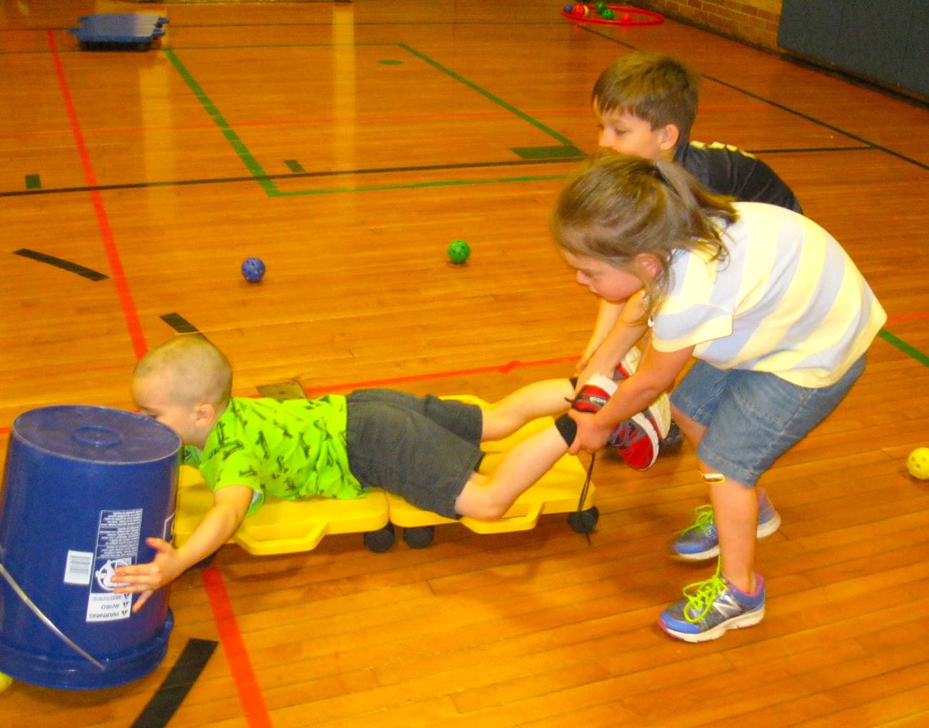 Kindergartners work together playing "Hungry Hippos"