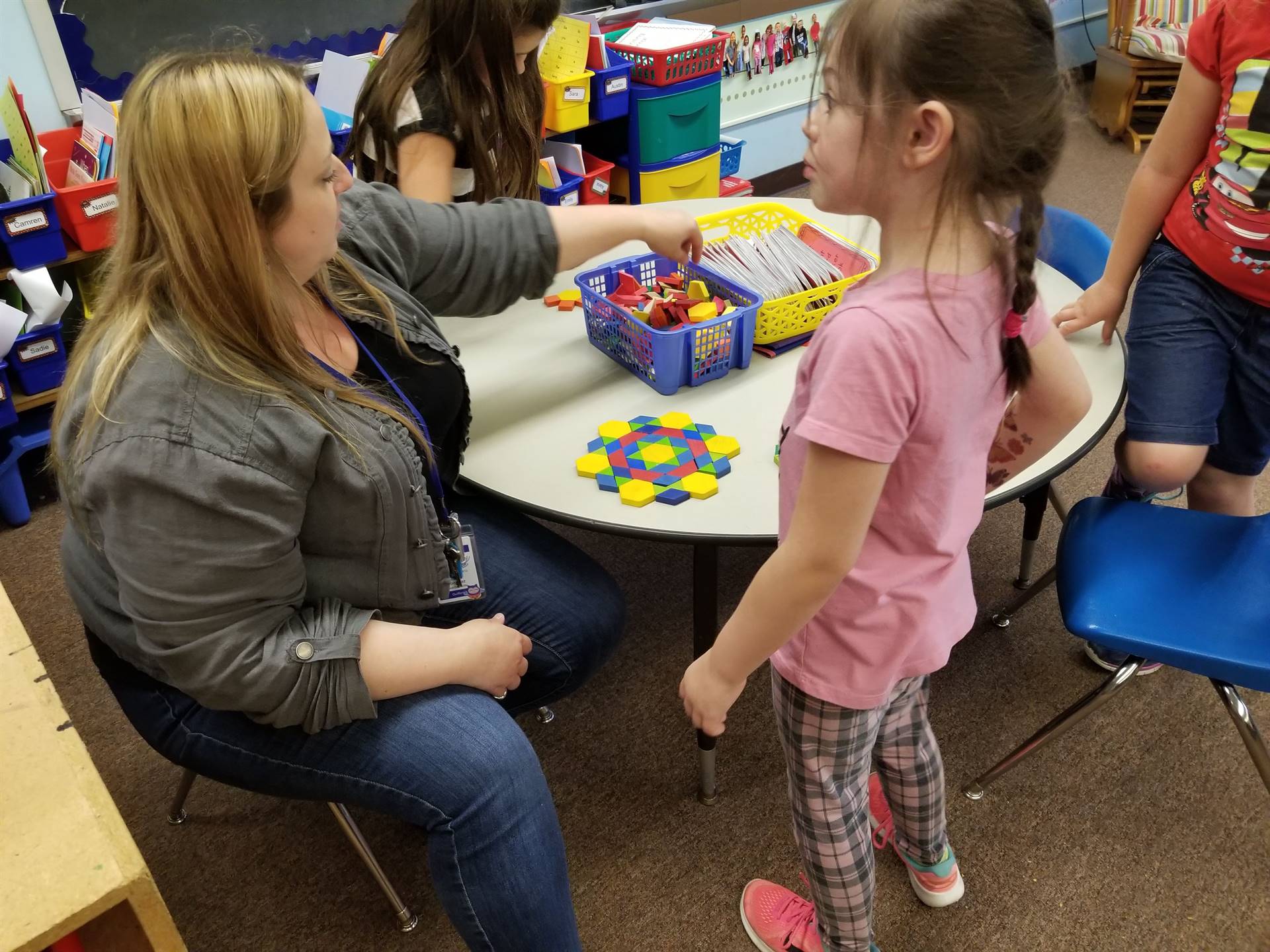 Student and staff create patterns with tiles shapes.