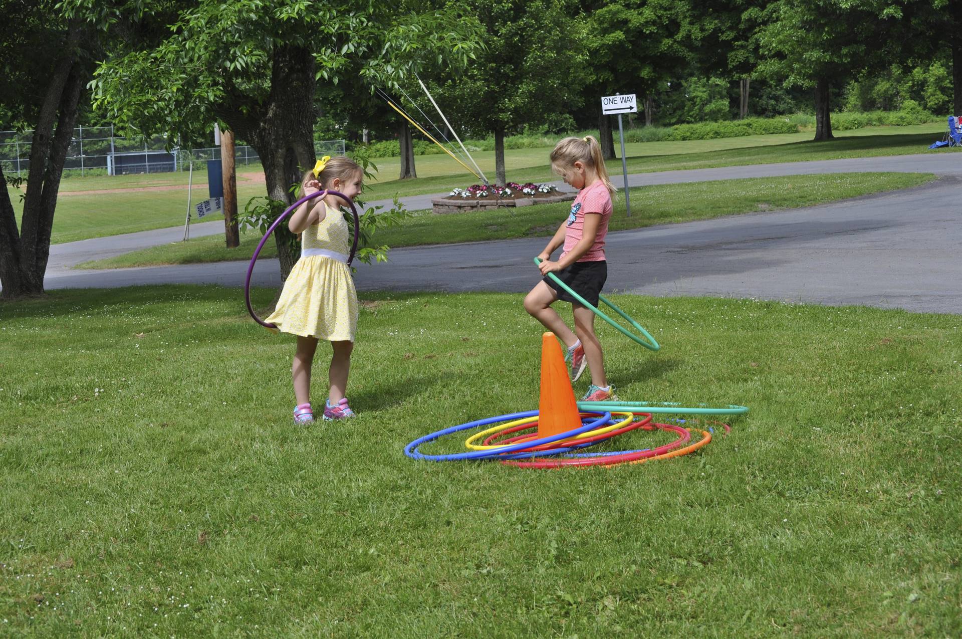 2 students try hula hoops.