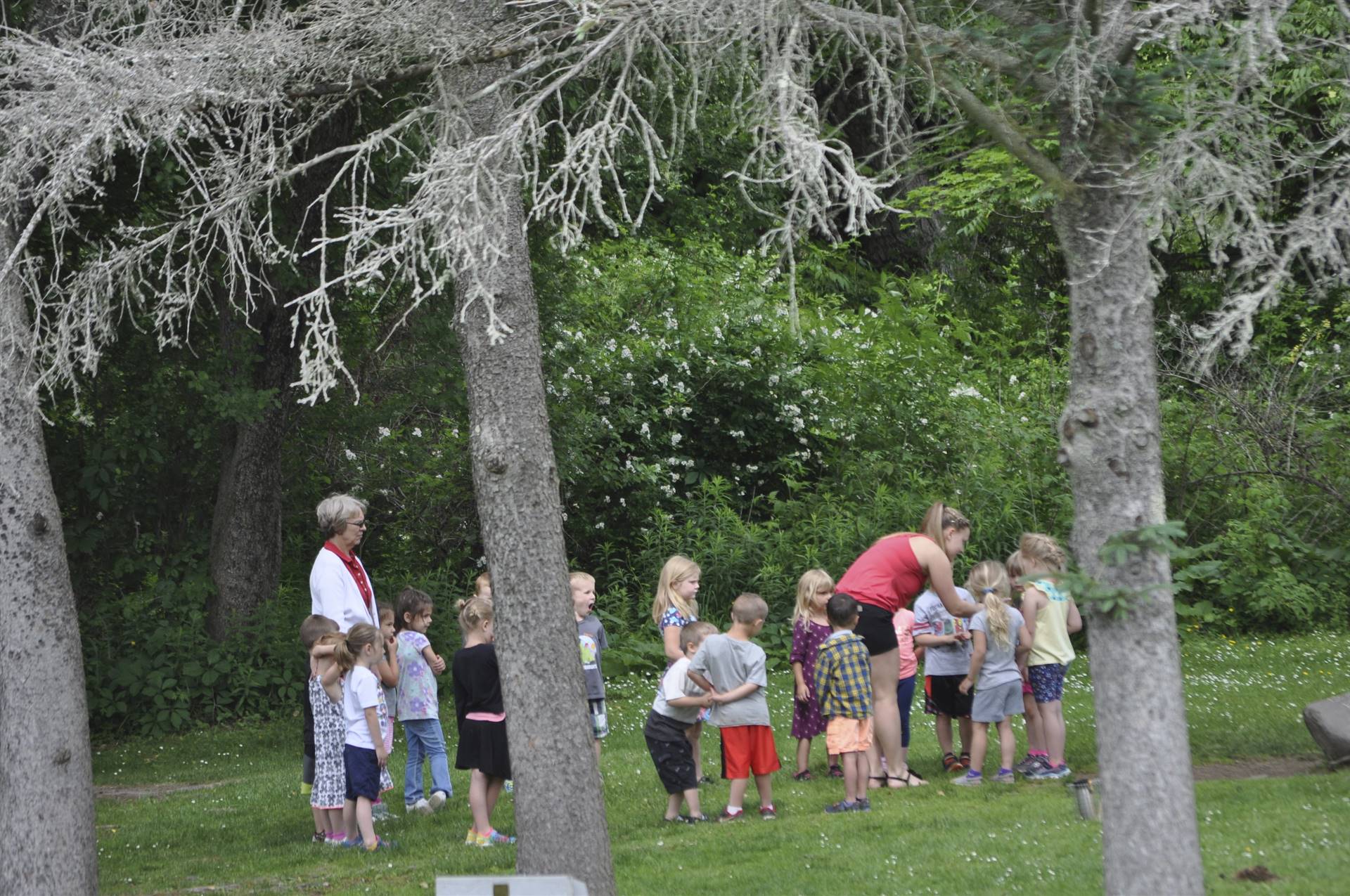 Students learn to sing a song at the campfire-song station.