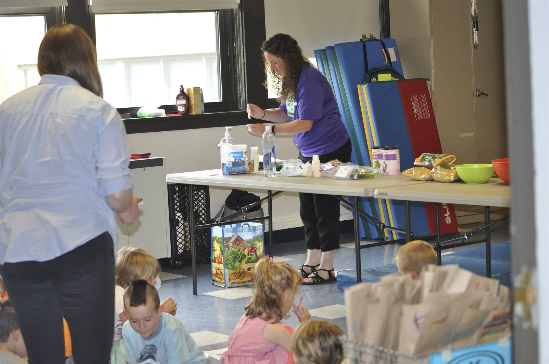 The Agriculture station helps students mix trail mix.