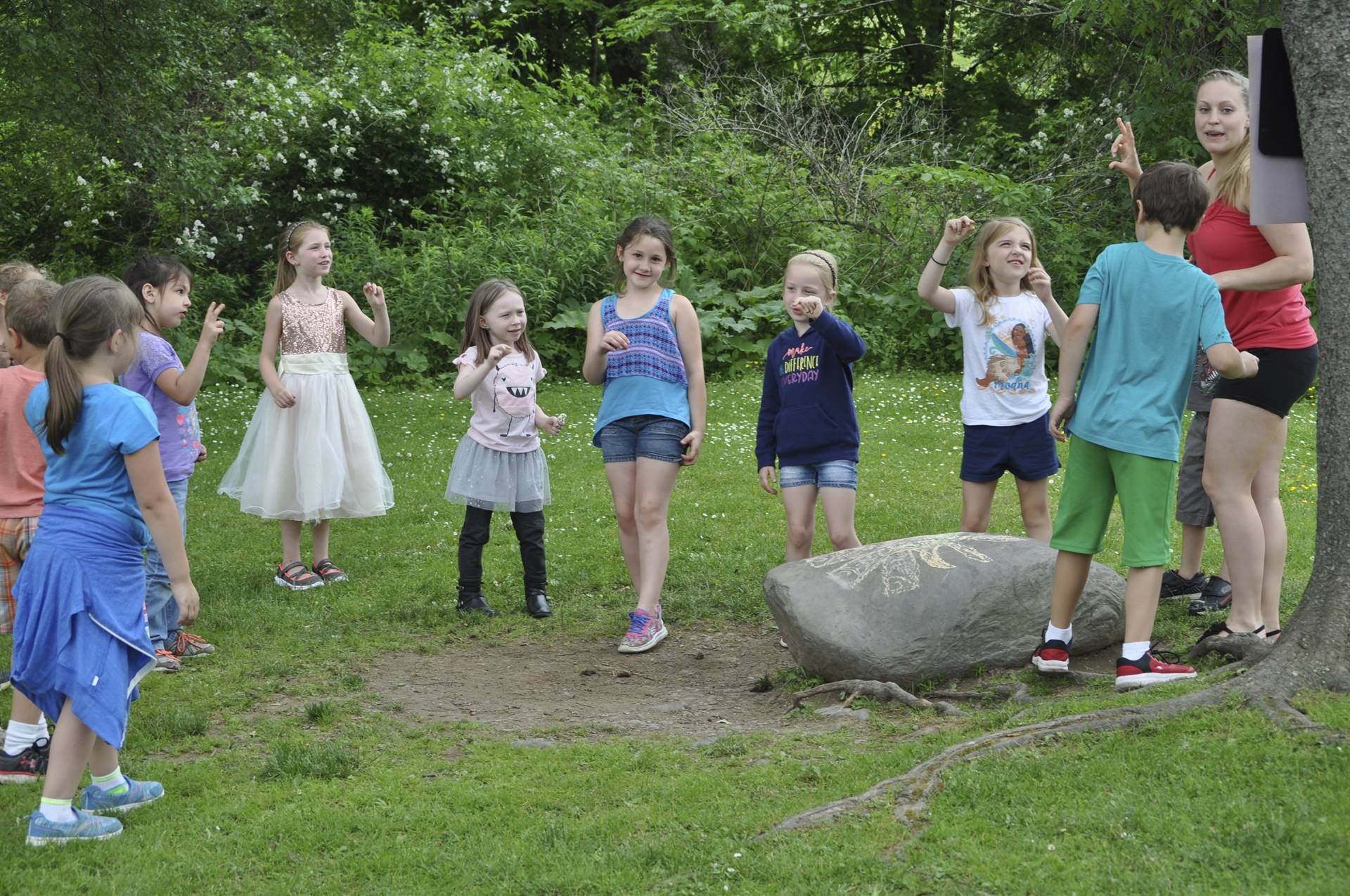 Students sing a song around the "campfire".