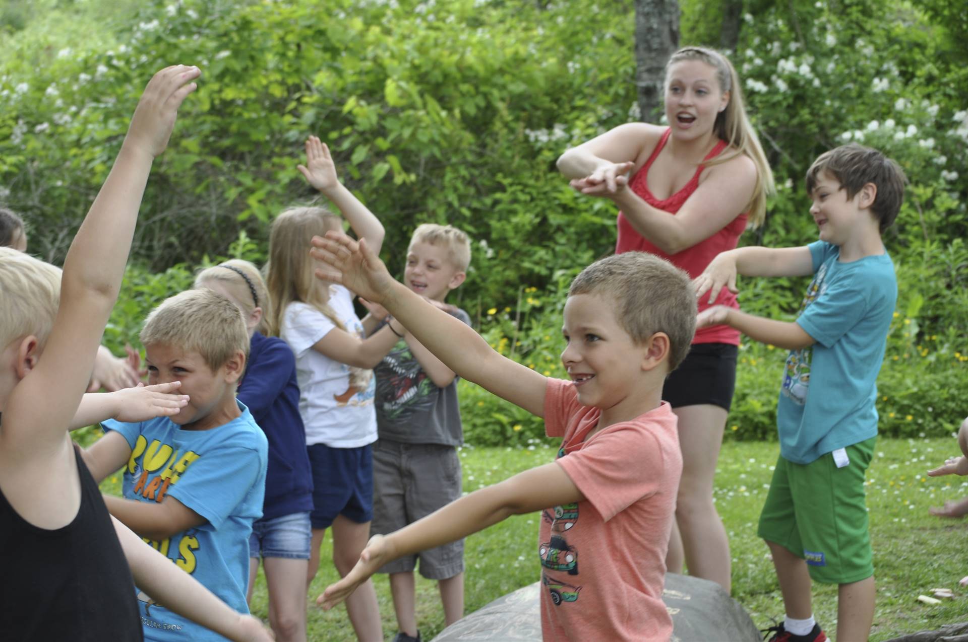 Students try a new song at the campfire station.