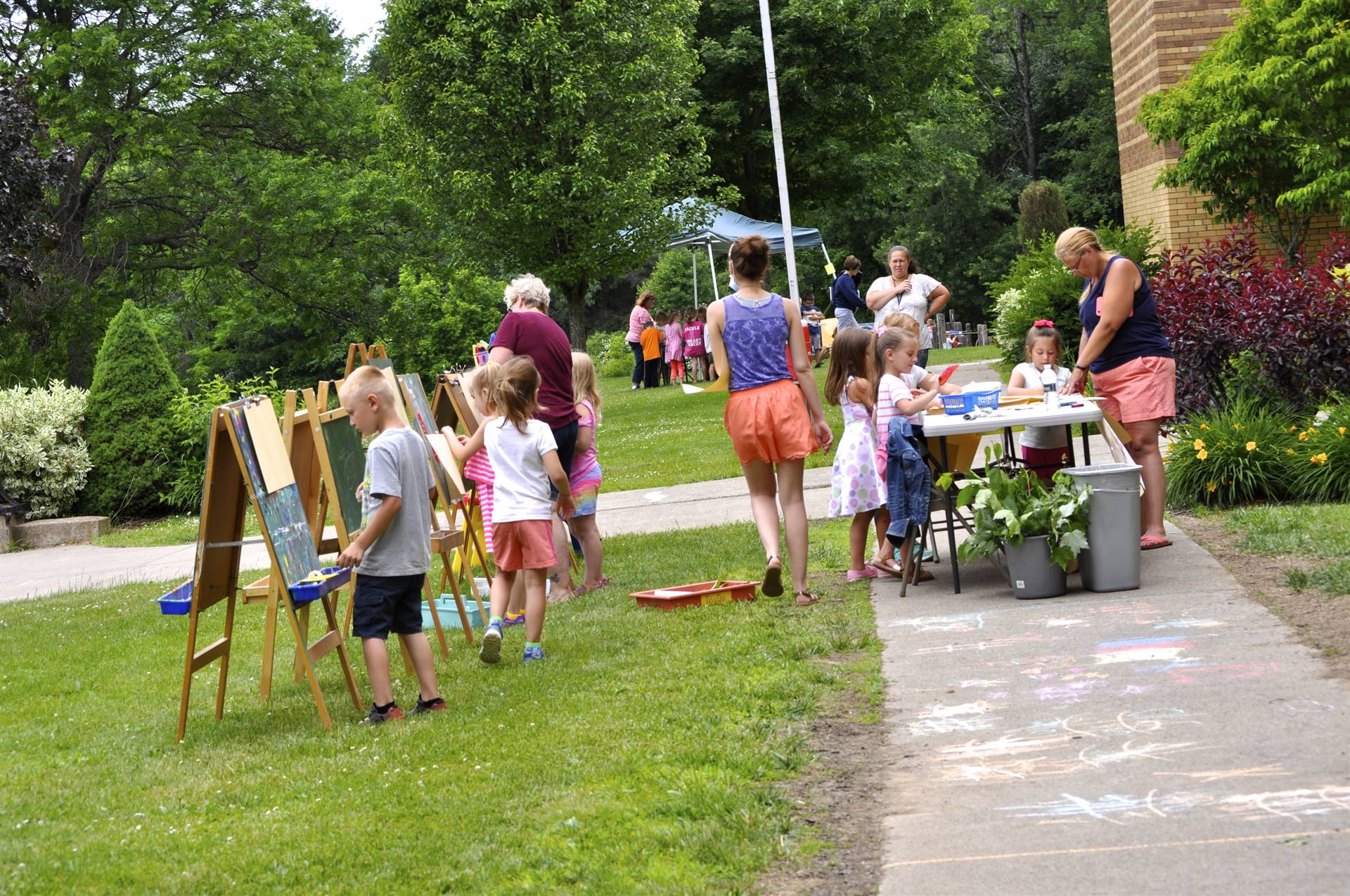 students try painting with sticks and leaves.