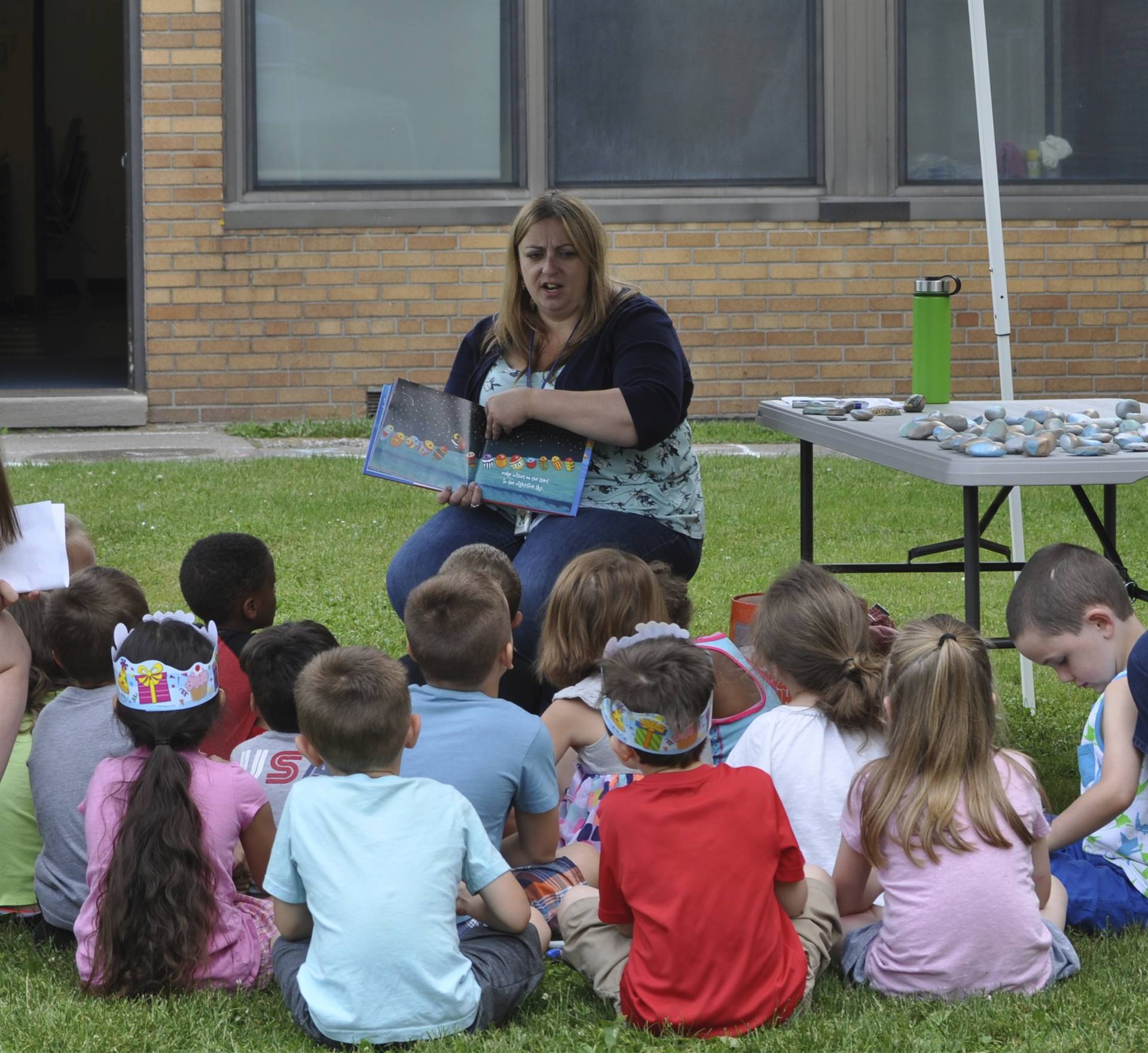 Ms. Gonzales reads a story to students on campout day.
