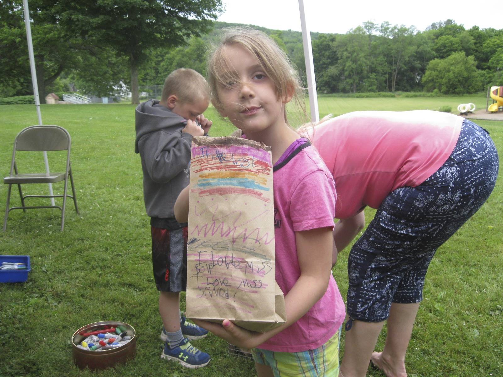 Student shows decorated bag to hold her campout treasures.