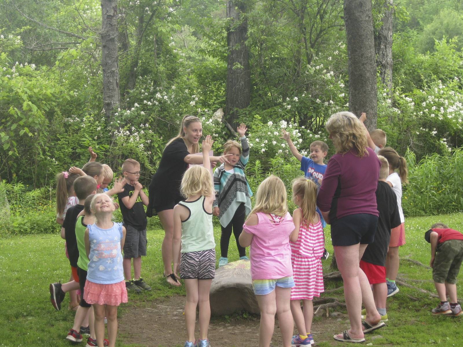 Students sing at a "campfire."