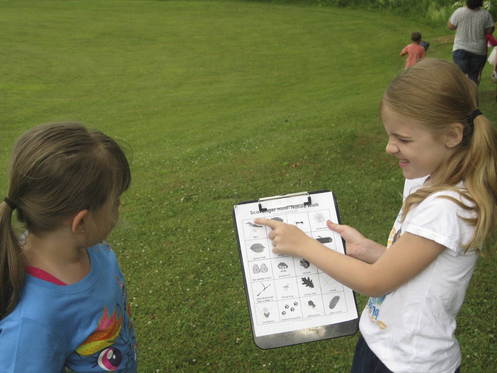 Student shows items she found during her hike.