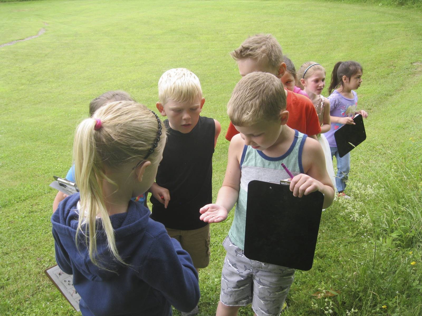 Students show what they found with each other on their hike.