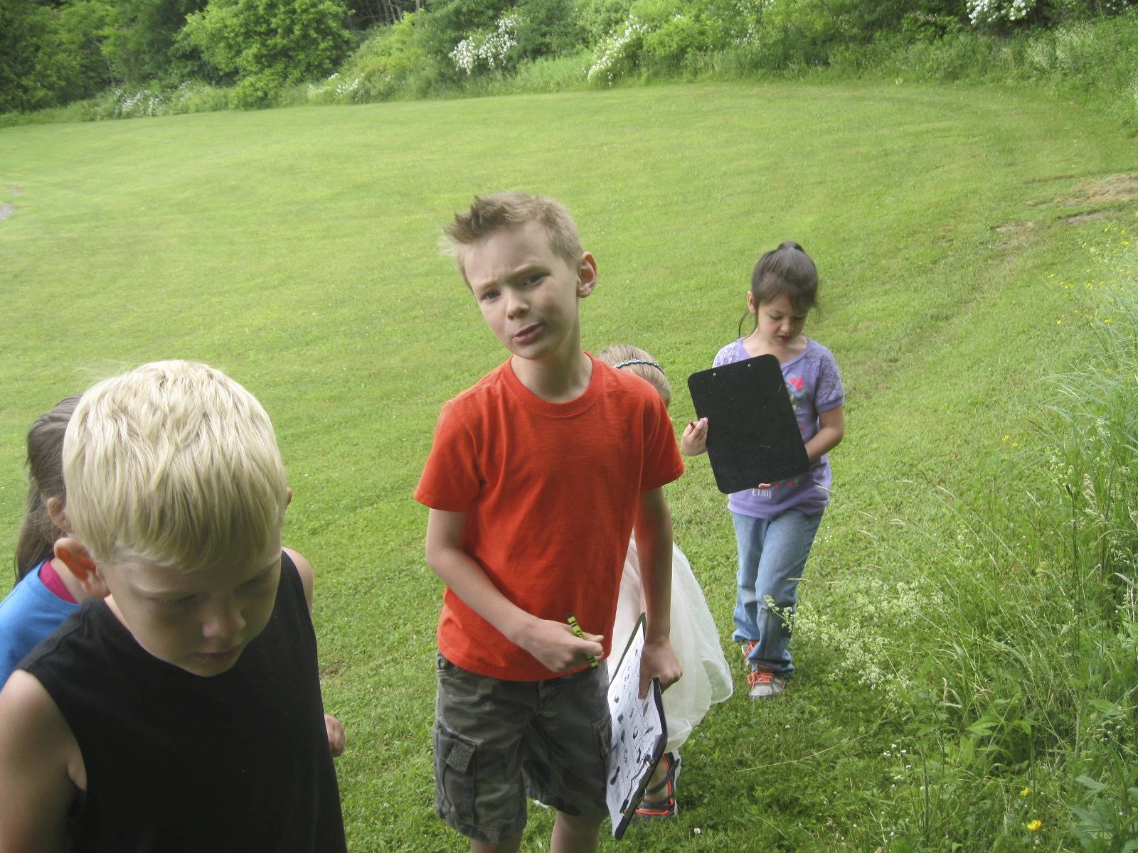 Students show what they found with each other on their hike.