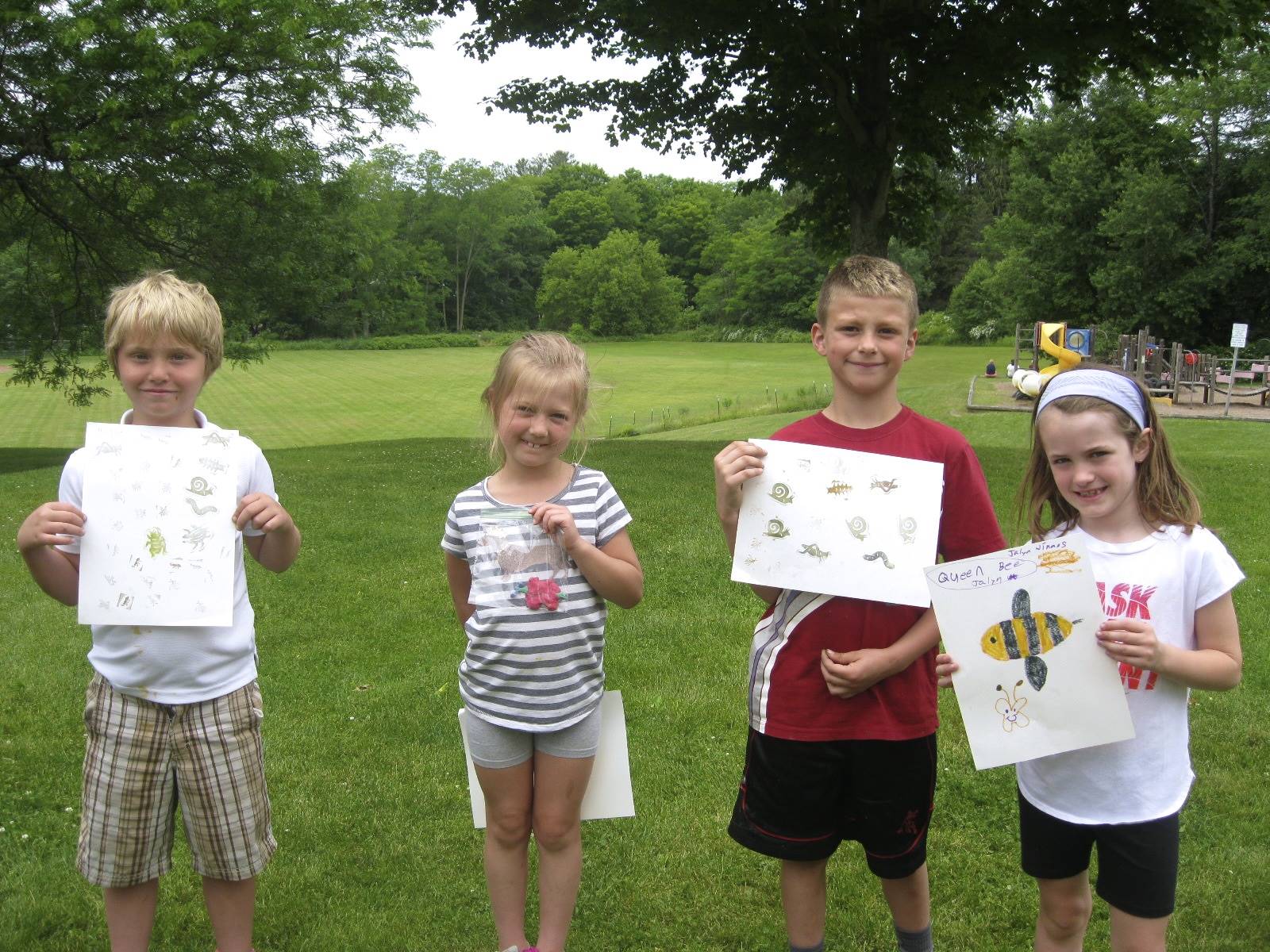 Students show off their bug stamping art.