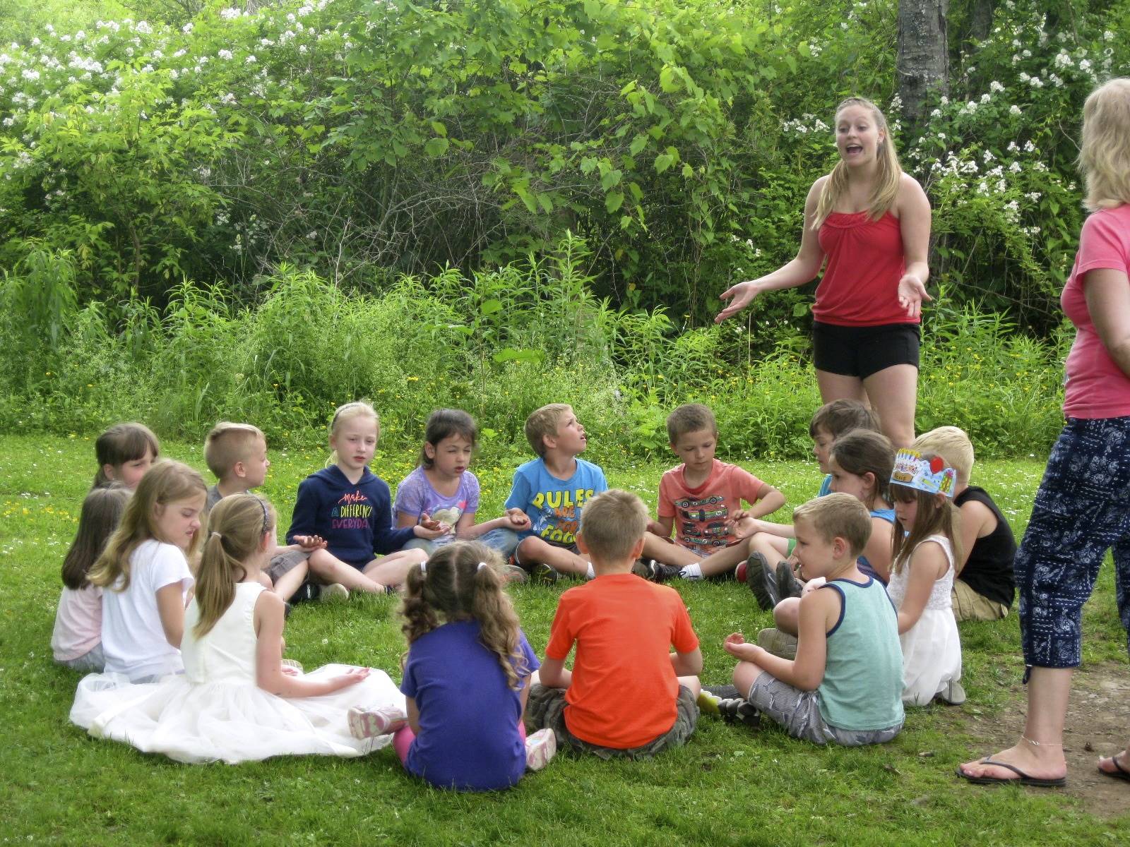 Students play a game around a "campfire".