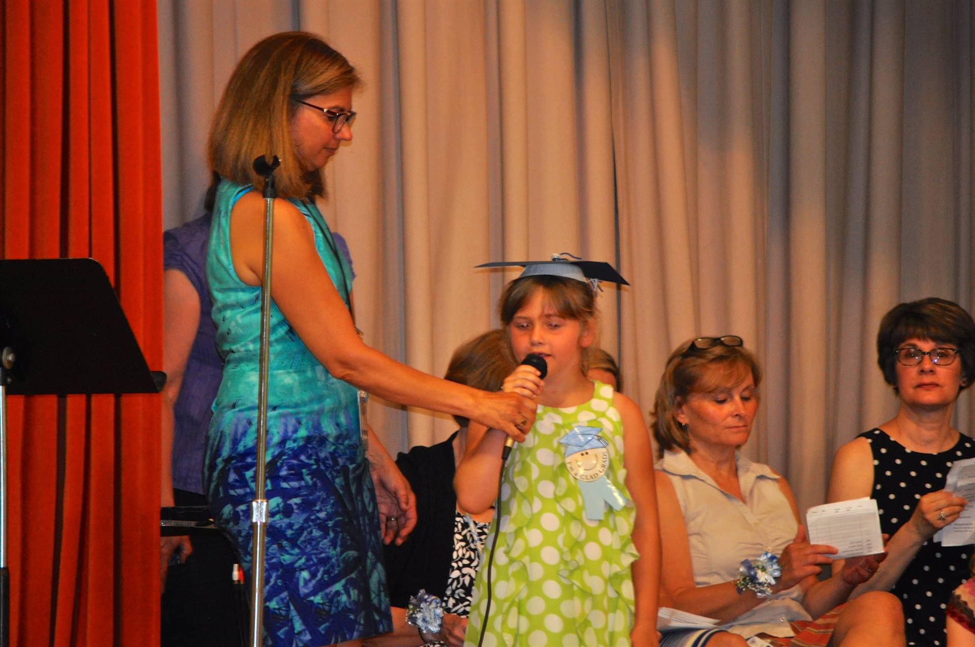 A student speaks into a microphone to give a direction.