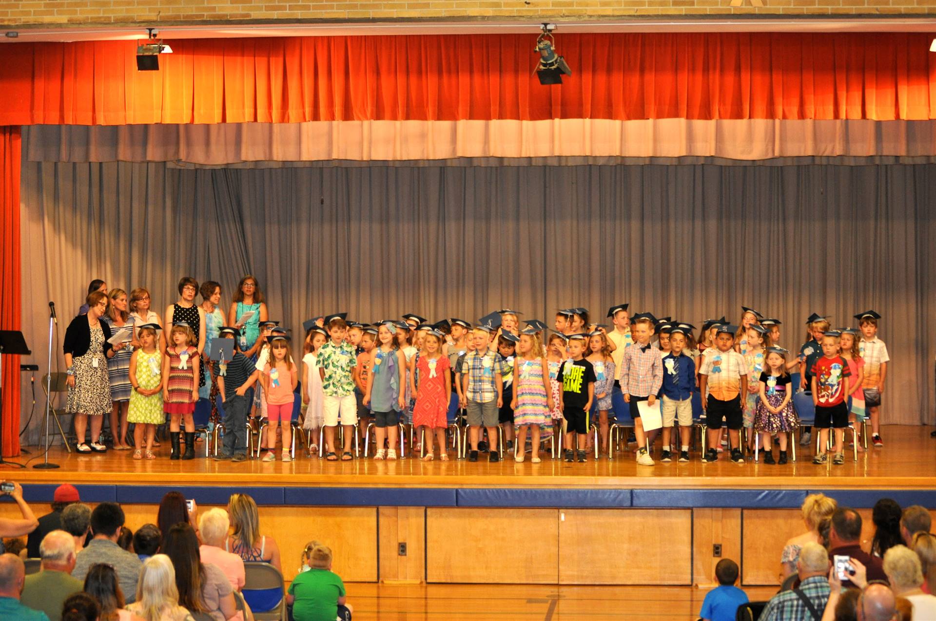 Students and staff of the first grade graduating class on stage!