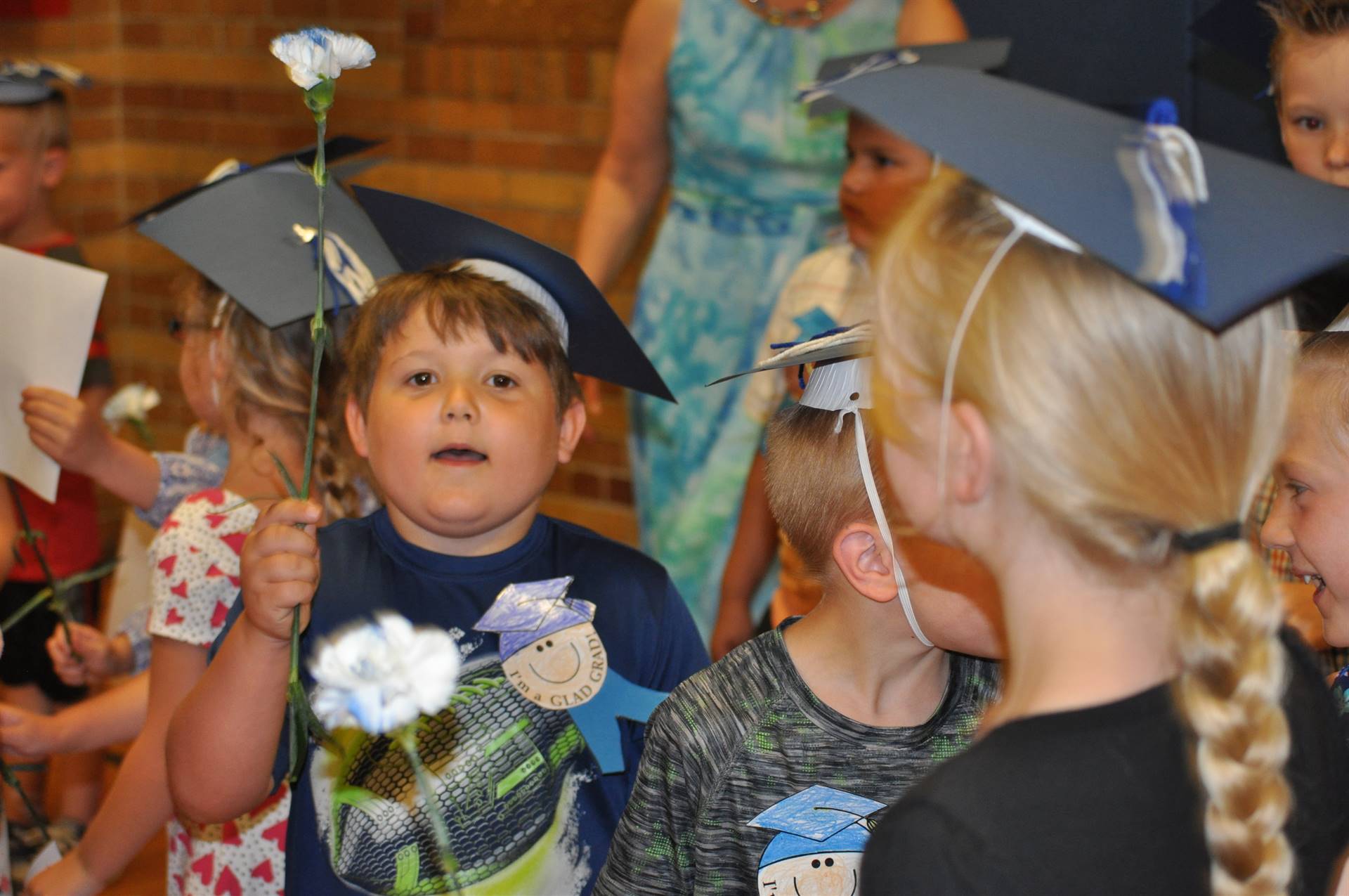 A student shows off carnations after the graduation ceremony.