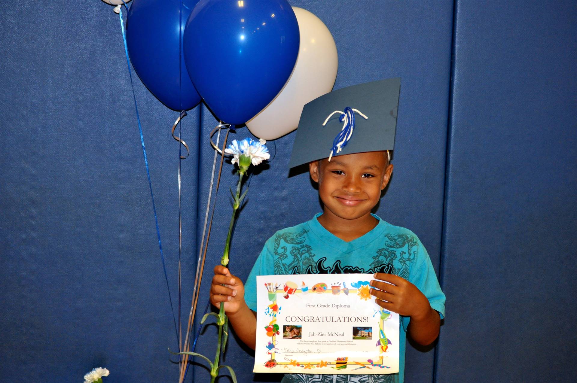 A student holds balloons to celebrate after the graduation ceremony.