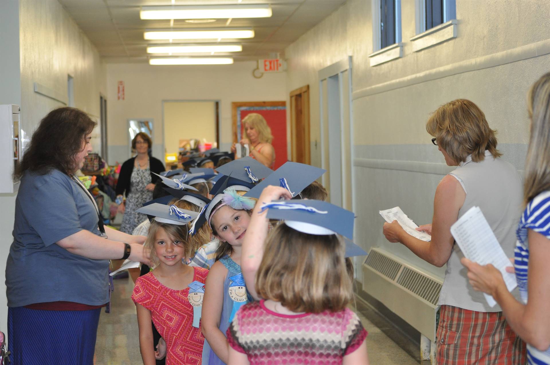 Teachers get first graders lined up in hallway.