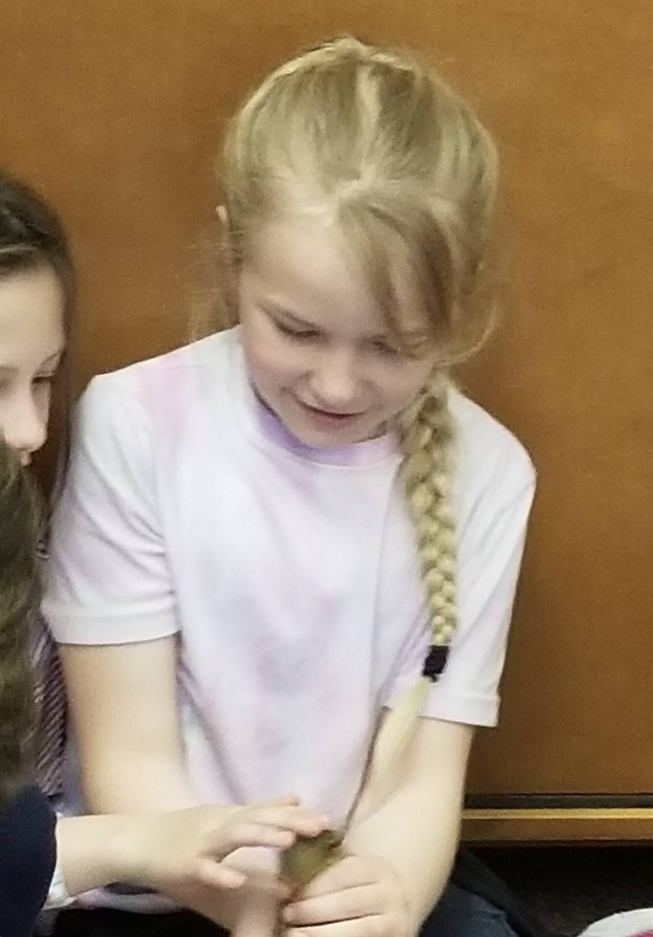 first grader holds a duckling.