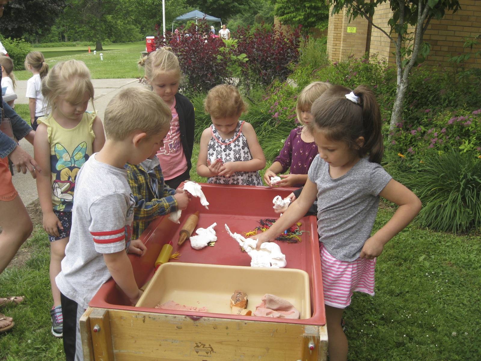 students explore stamping animal prints in clay.