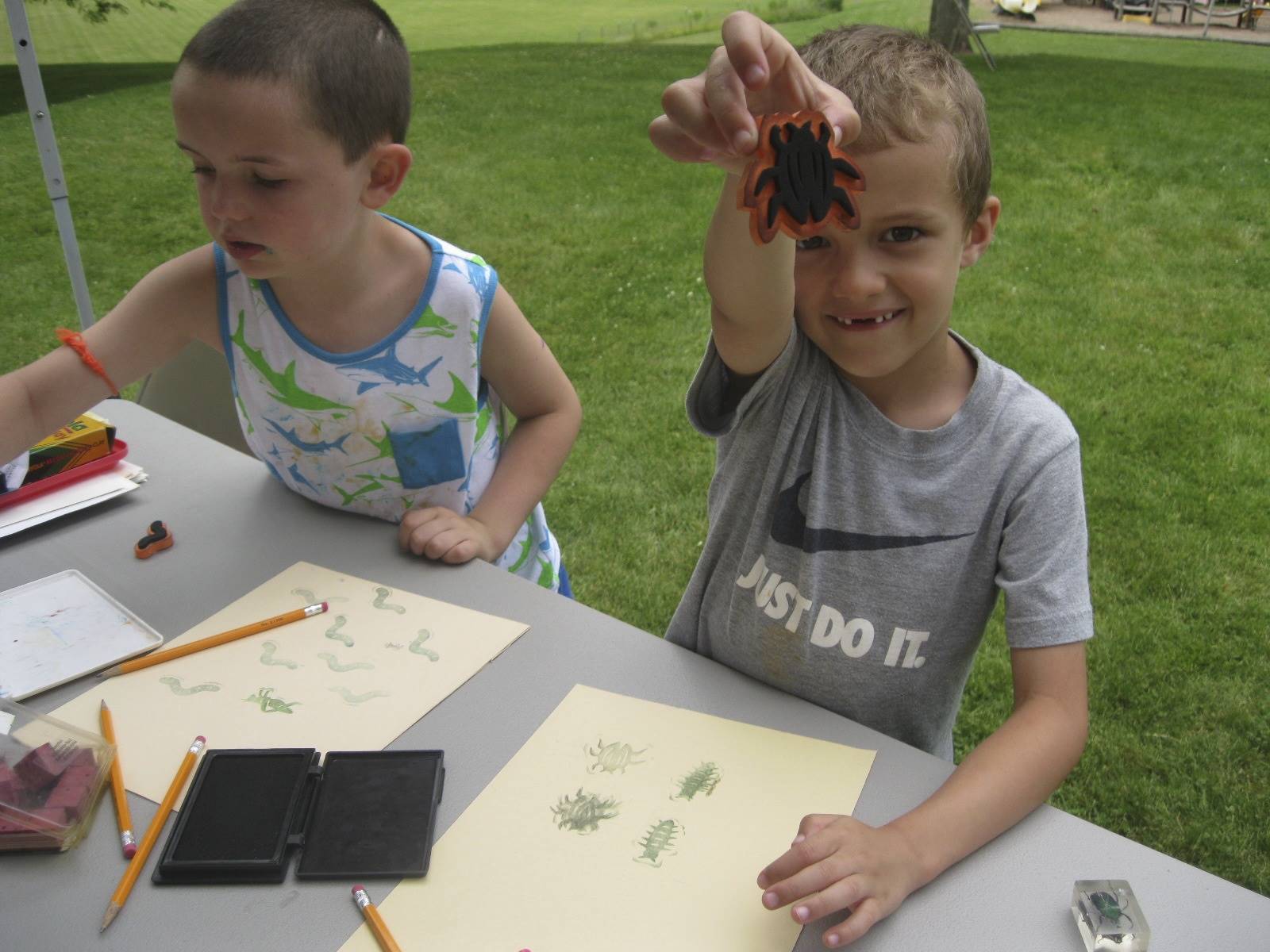 student shows his bug stamper.