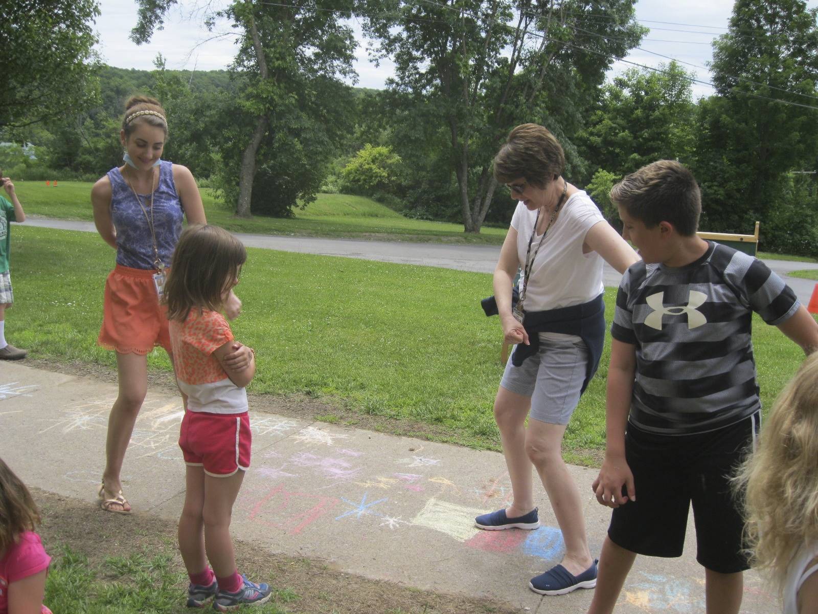 teachers and students dance at the paint station. 