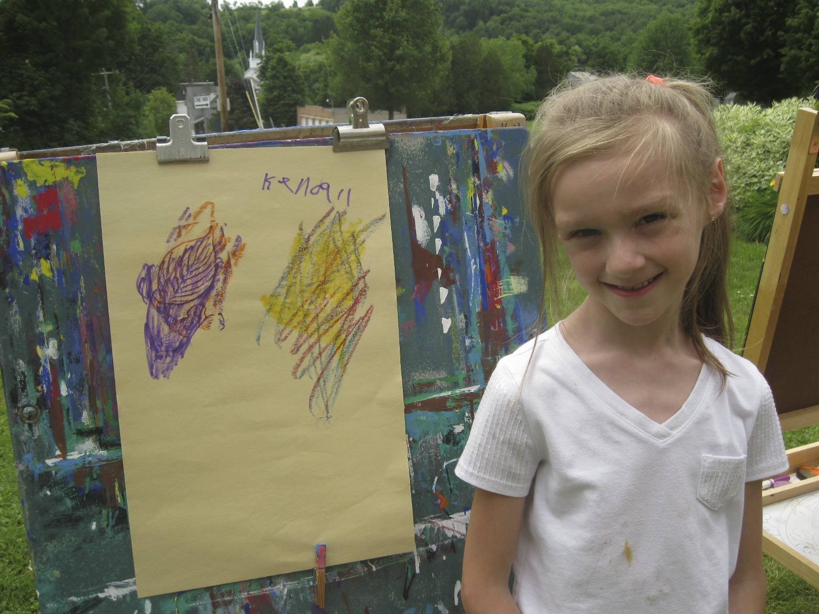 A student shows off her artwork.