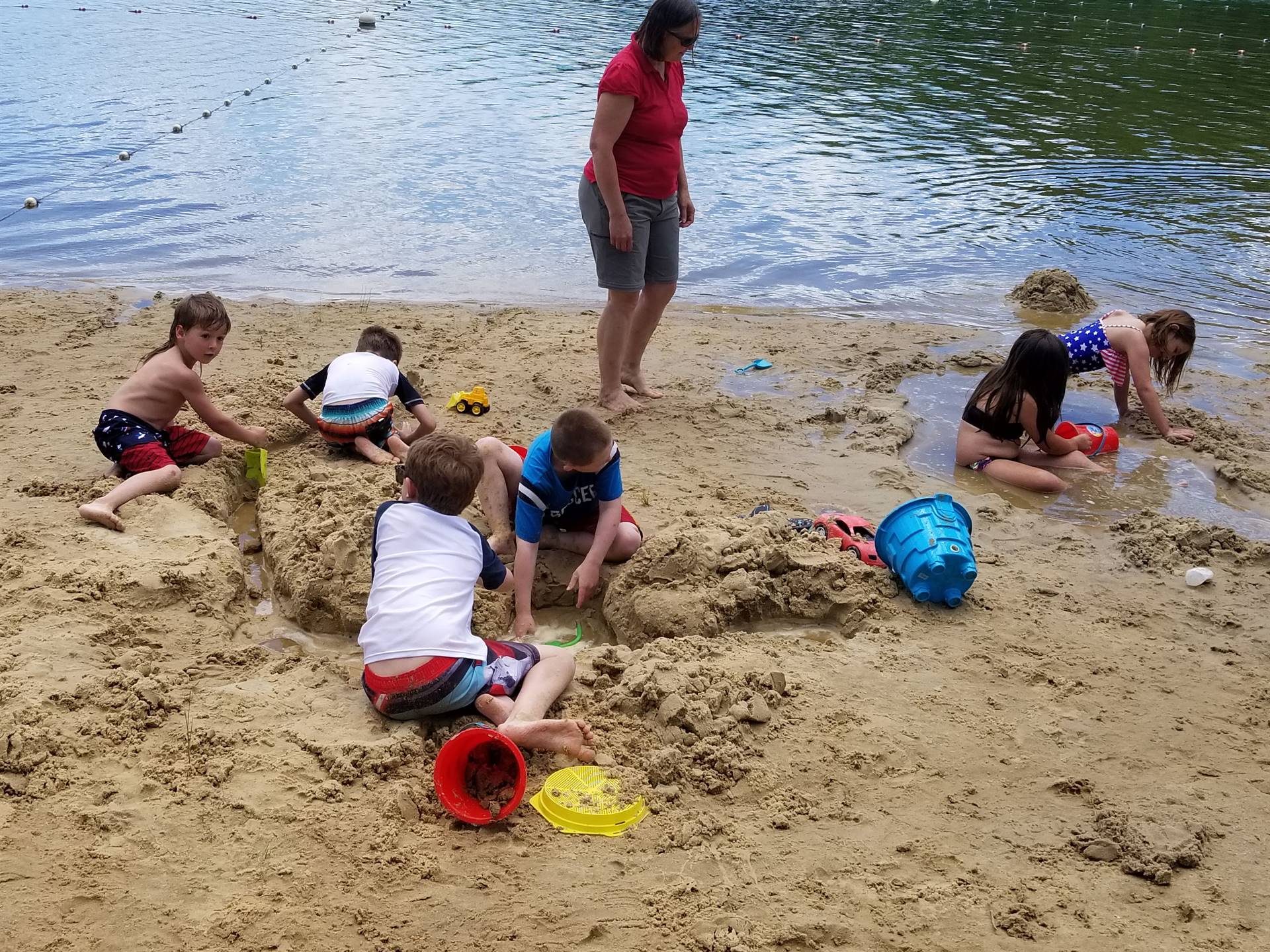 student engineers create sand castles at the beach.