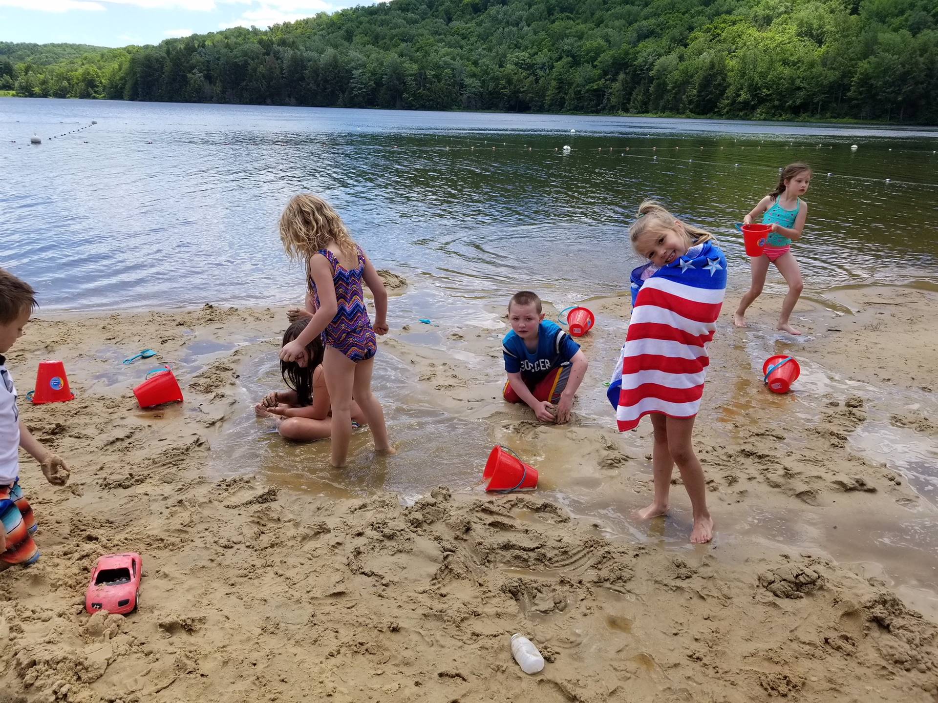 Student engineers build and create in sand.