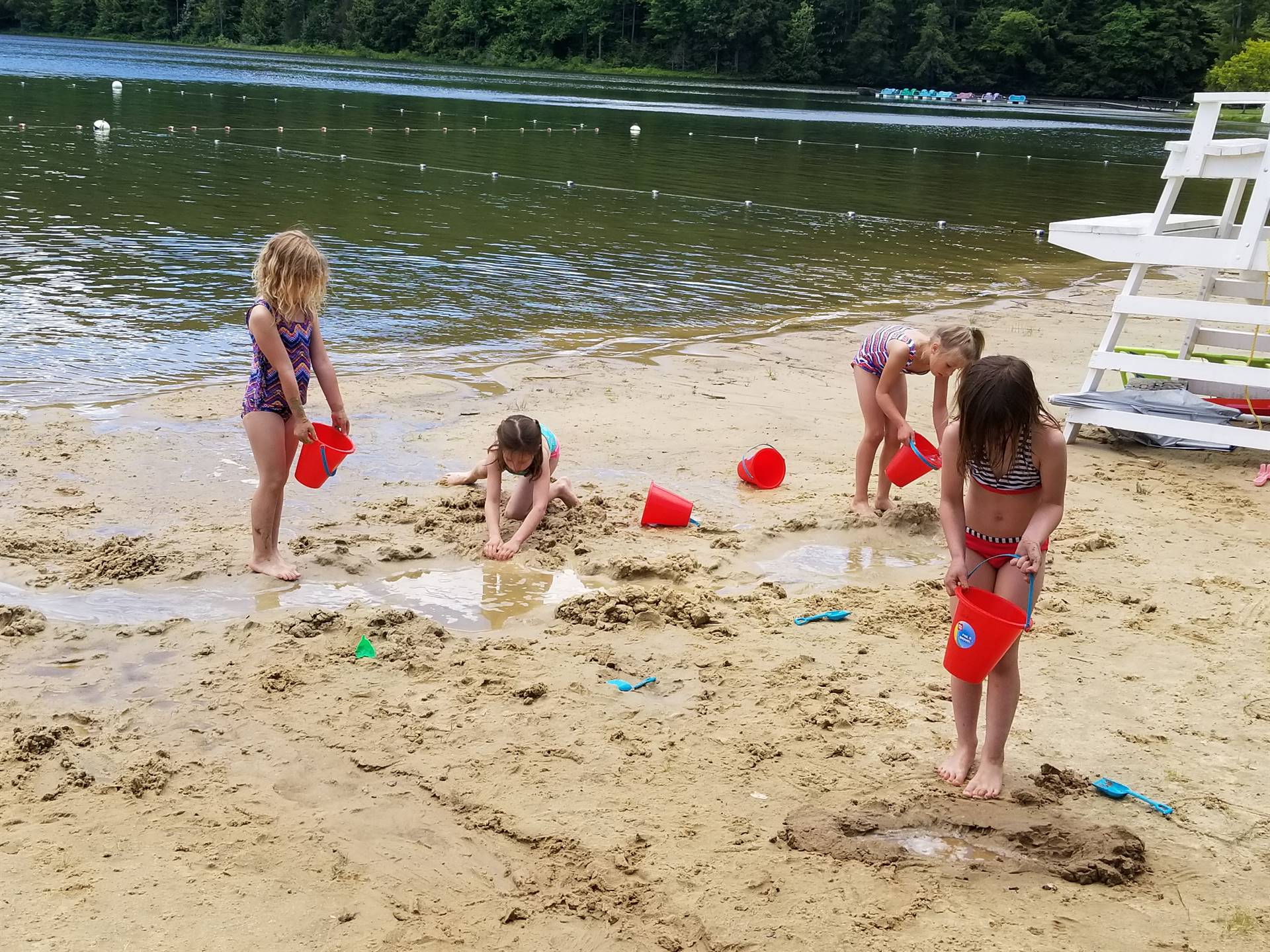 students practice filling and emptying buckets.