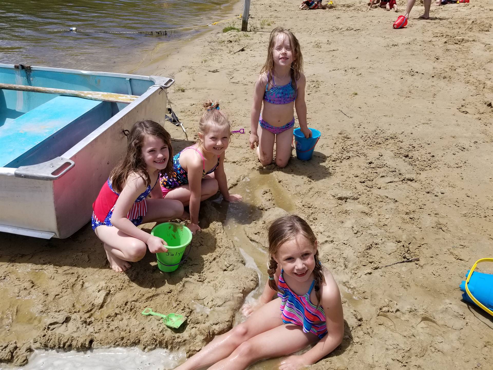 students show off their mini pond they built.