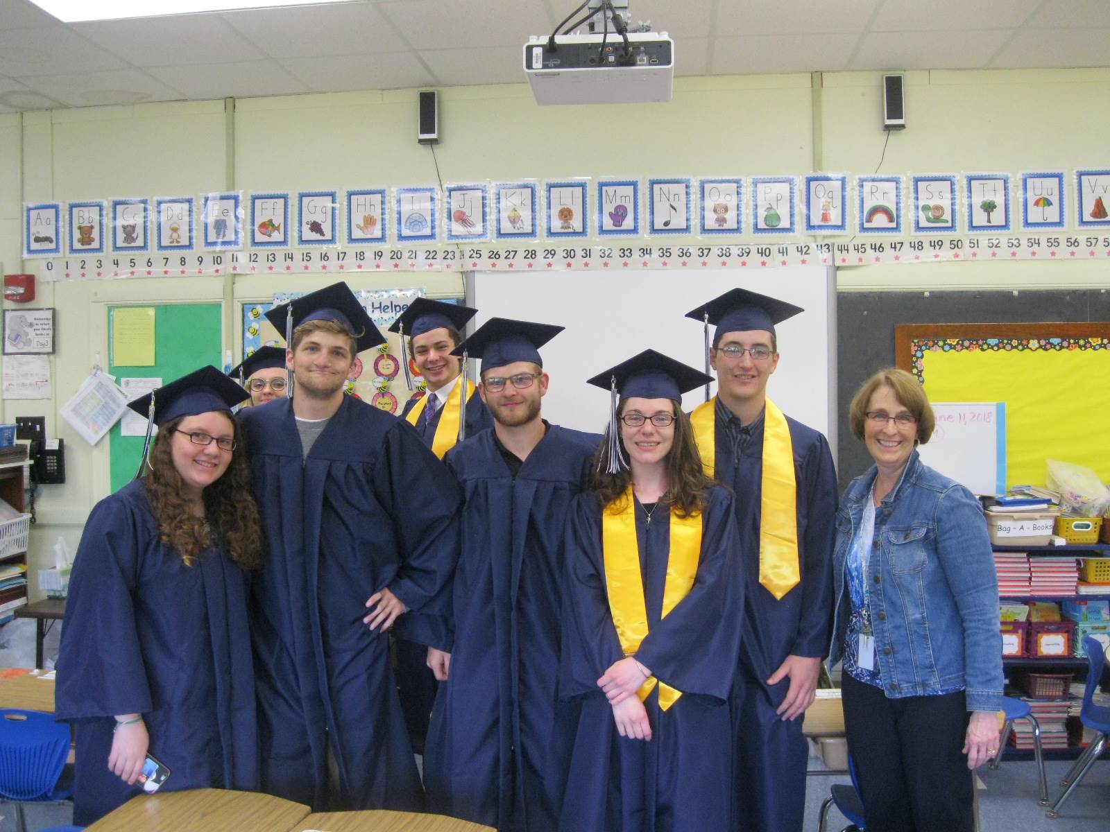 Seniors pose with a teacher.